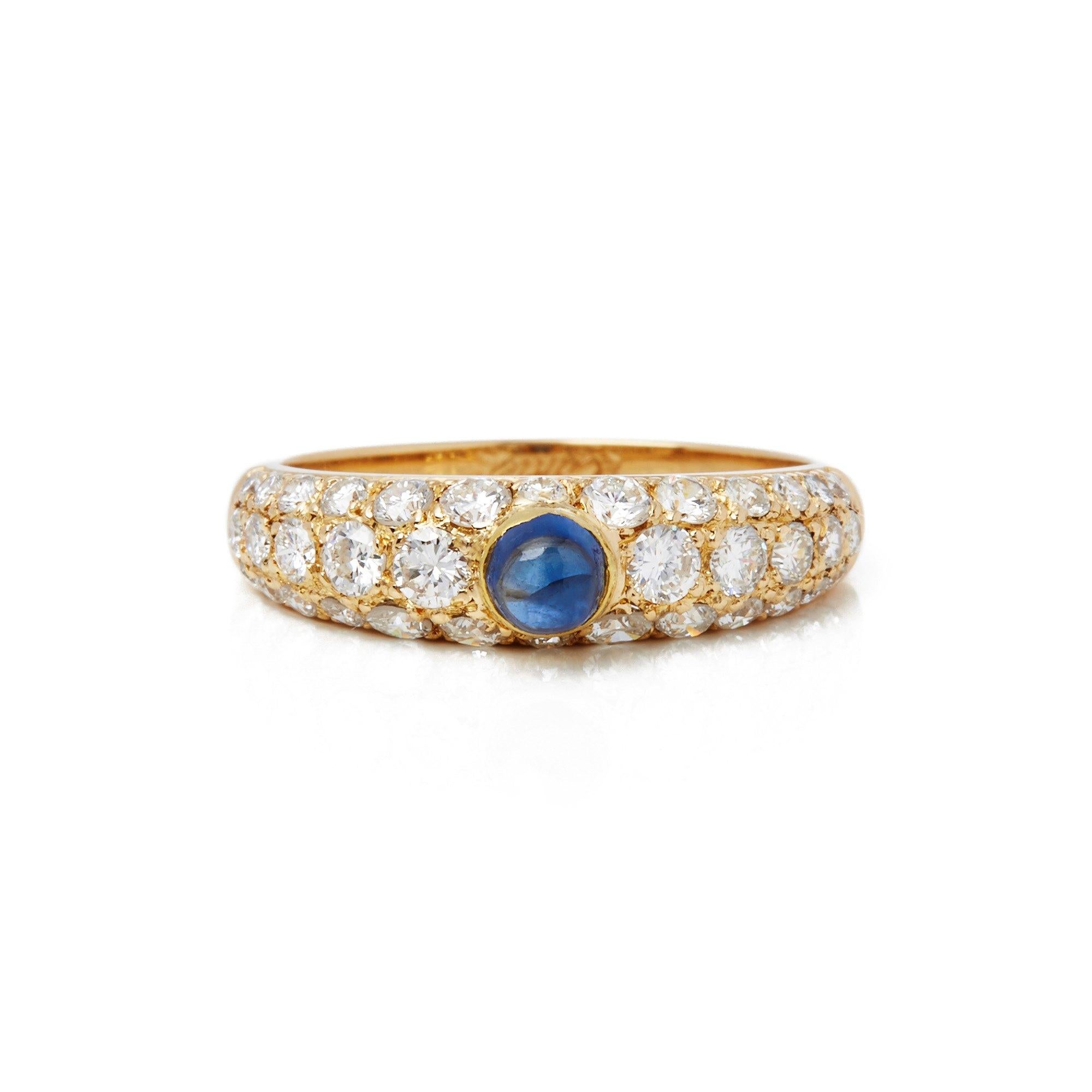 Ring by Cartier features One 0.20ct Cabochon Cut Sapphire Set with Thirty Six Round Brilliant Cut Diamonds Pave Set Mounted in an 18k Yellow Gold Band. Total diamond weight 1.22ct. Finger Size UK M, EU 53, USA 6 1/2. Complete with Original Cartier