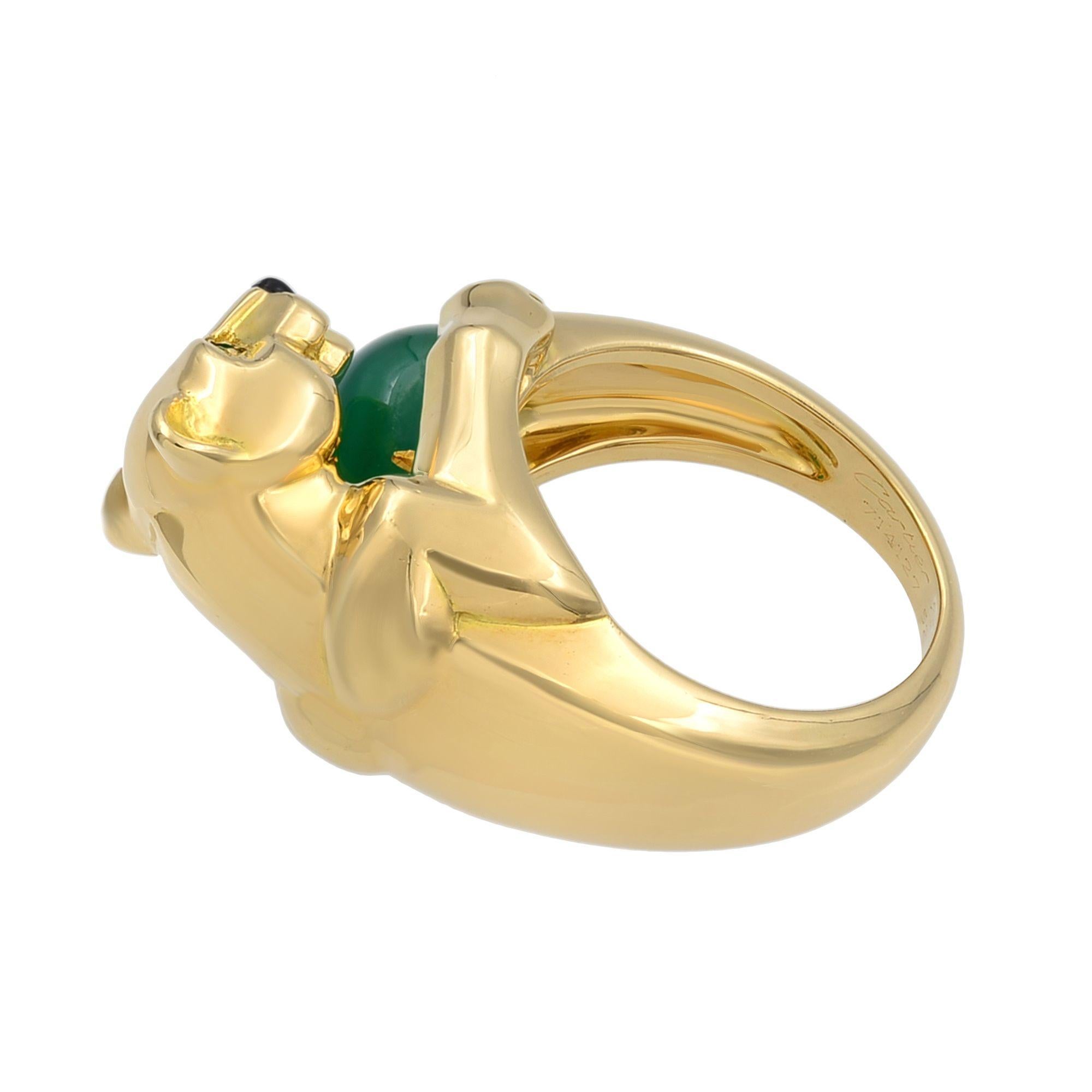 Cartier Panthere ring, set in solid 18k yellow gold. This rare version of Panthère de Cartier ring prominently features a polished yellow gold panther motif holding a beautiful polished green chalcedony bead. The panther is also set with matching