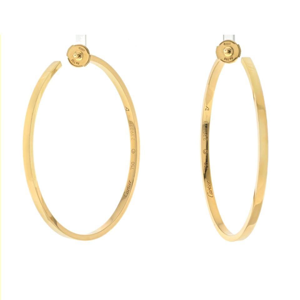 A timeless masterpiece of luxury and elegance - the 18k yellow gold Cartier diamond hoop earrings.  

The focal point of these hoop earrings is the breathtaking arrangement of round cut diamonds, meticulously set in a dazzling inside-out pattern.