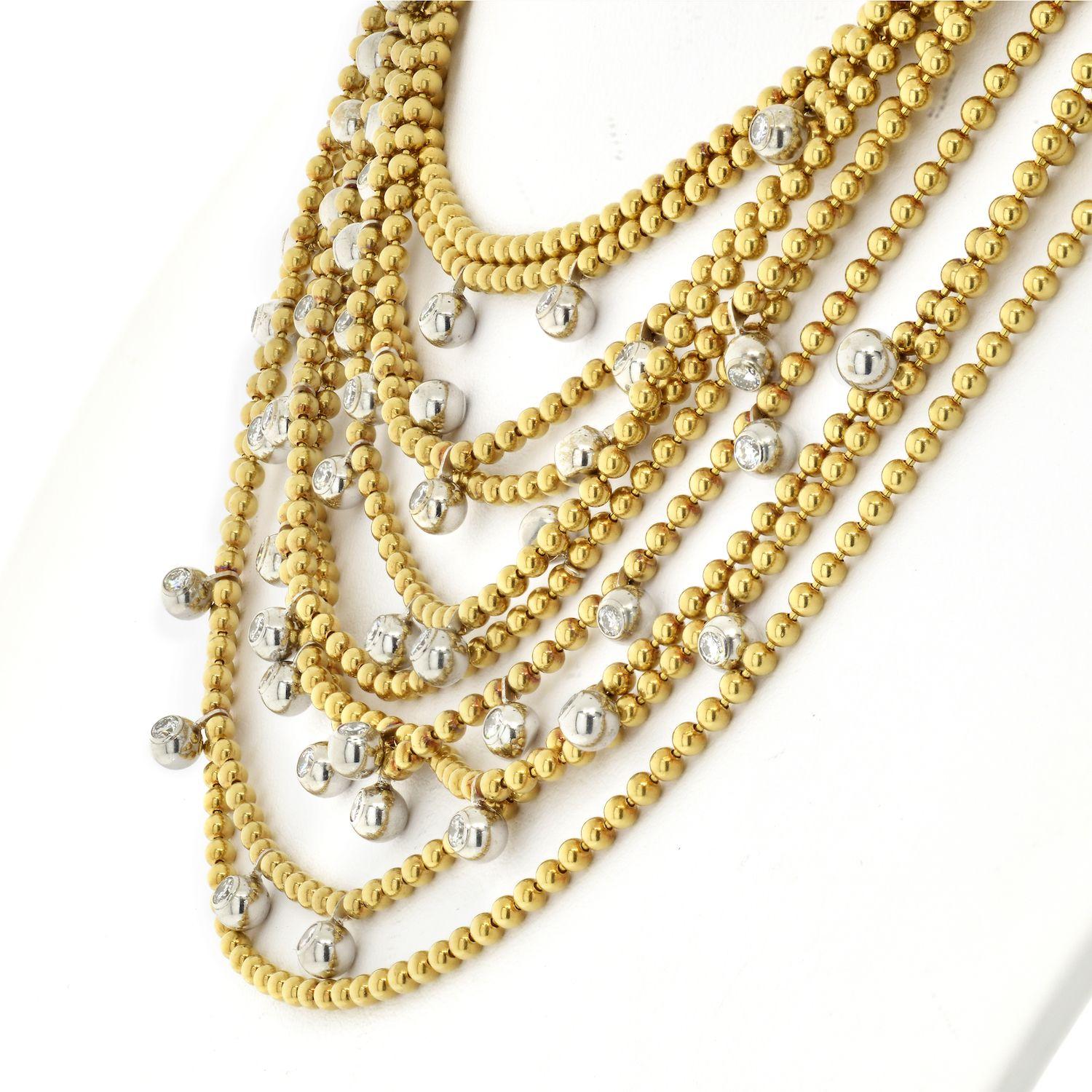 Composed of ten strands of polished beads, set intermittently with a fringe of round diamonds. Cartier 18K Yelow Gold Diamond Drapery necklace set with 44 brilliants dispatched on 10 rows of bid chains.
Diamonds: 44 round diamonds with approximate