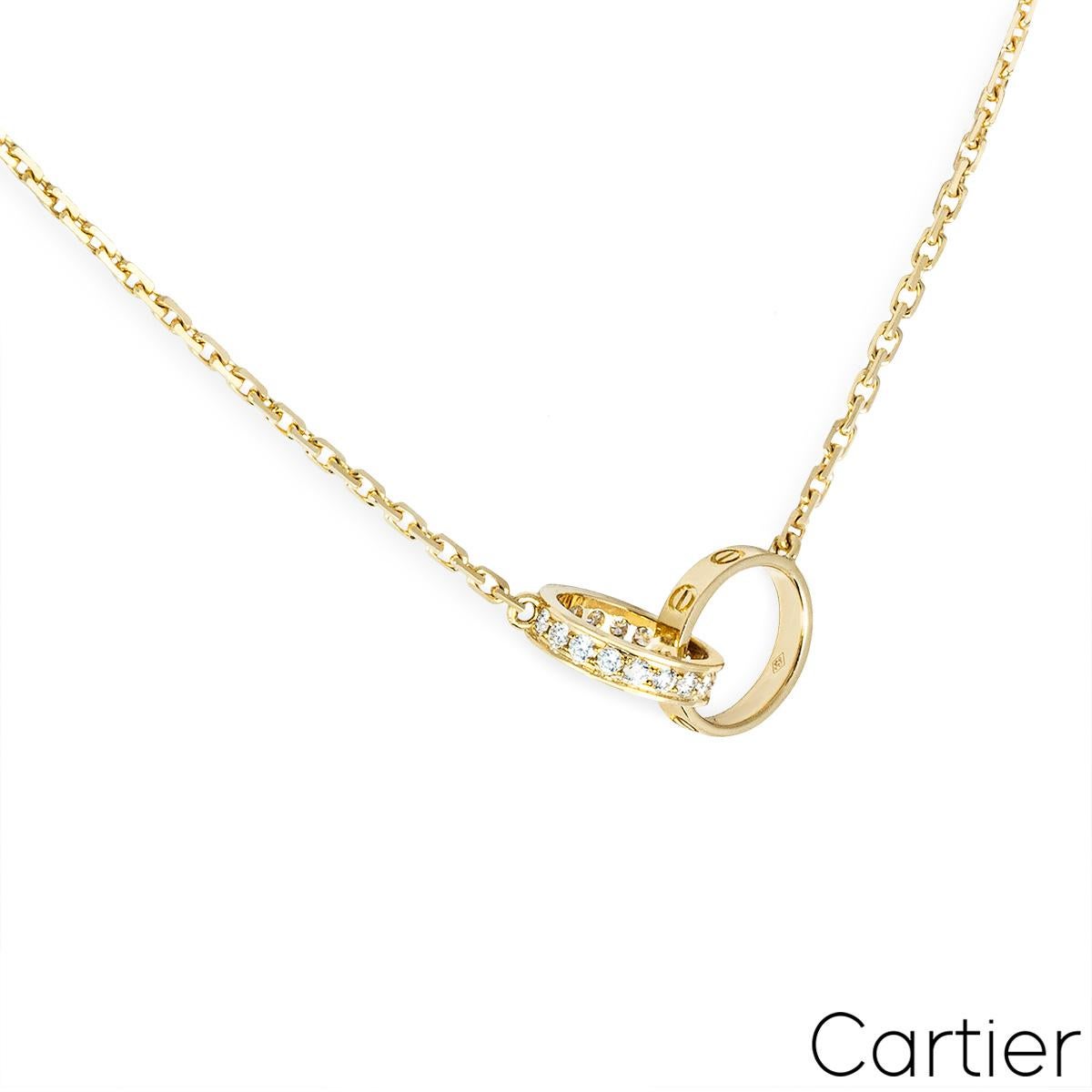 A delicate 18k yellow gold necklace from the Cartier Love collection. The necklace features two interlocking circular motifs set to the centre, one set with the iconic screw motif throughout and the other pave set with 18 round brilliant cut