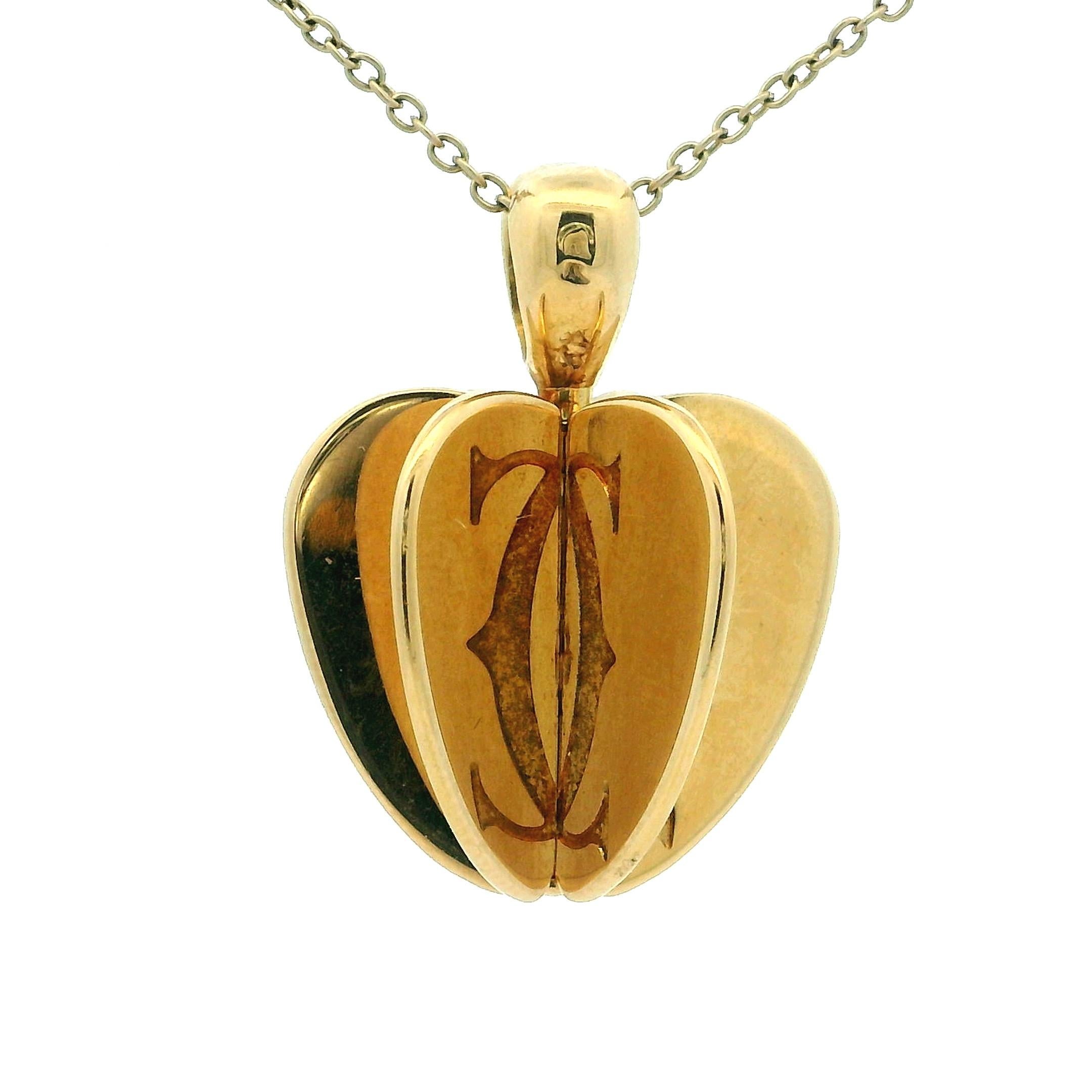 A crafted Cartier 18 karat yellow gold Double C 3D Apple Heart pendant, showcasing the Maison’s mastery of sculptural design and timeless romance.
This elegant pendant features a three-dimensional heart form composed of two interlocking halves that