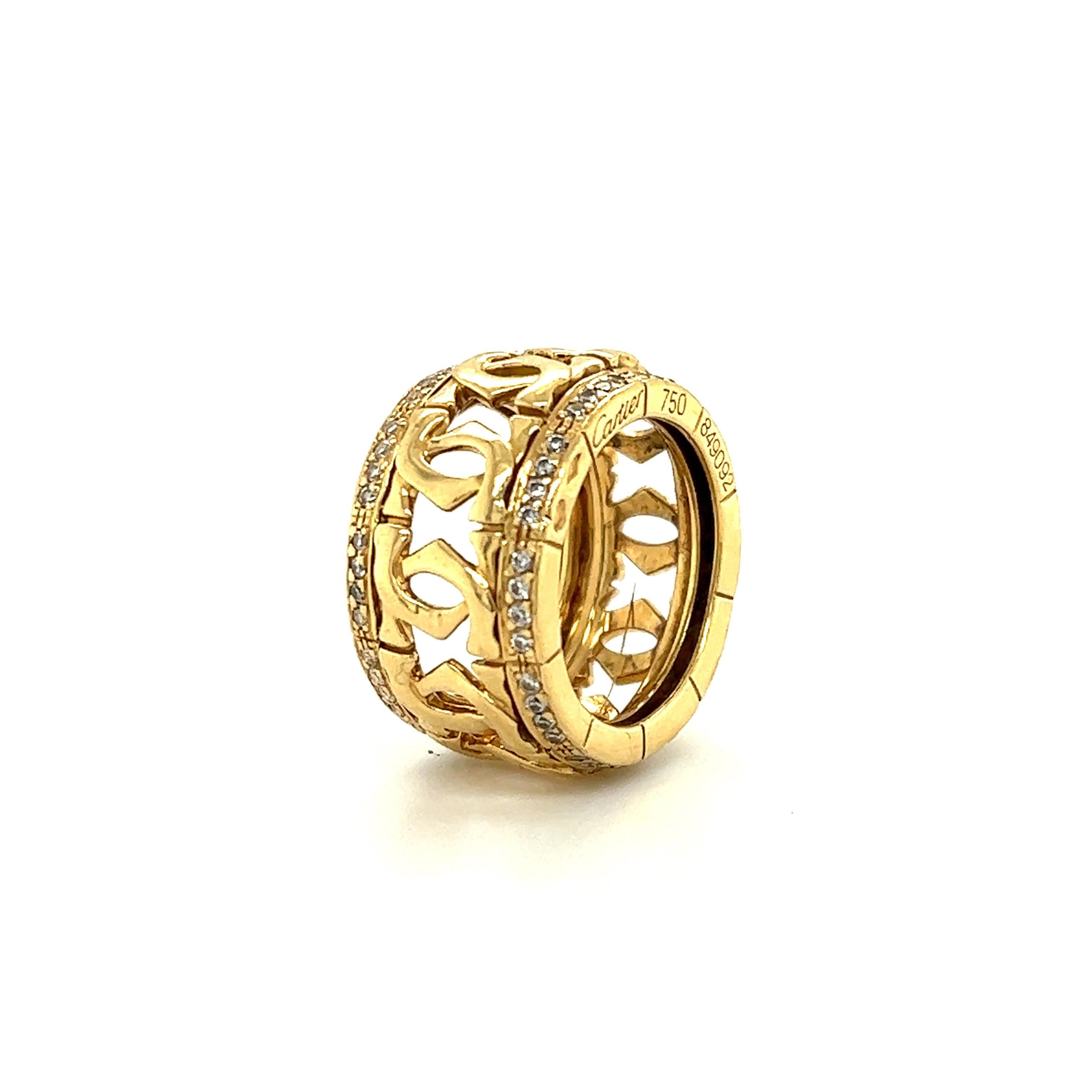 Gorgeous vintage ring from famed designer Cartier. The ring is crafted in 18k yellow gold and is a wide band design. The ring shows a 12.75 mm width.
The ring shows the double C pattern throughout the center of the ring, with accenting round