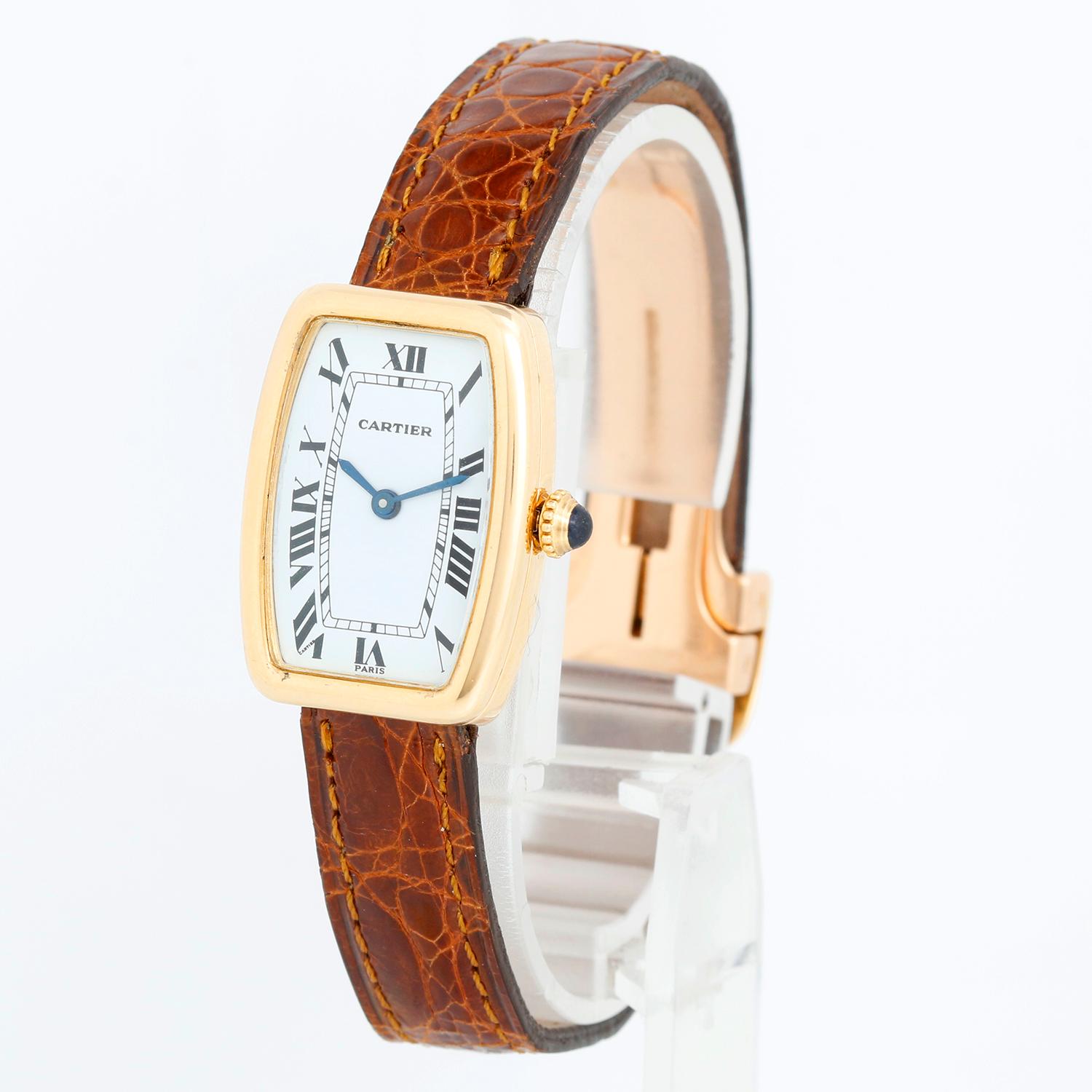 Cartier 18K Yellow Gold Faberge Tonneau Watch - Manual Movement. 18K Yellow gold ( 20mm x 27mm ). White dial with black roman numerals. Brown Cartier leather strap with 18K Yellow gold deployant clasp. Pre-owned with Cartier box. Circa 1970