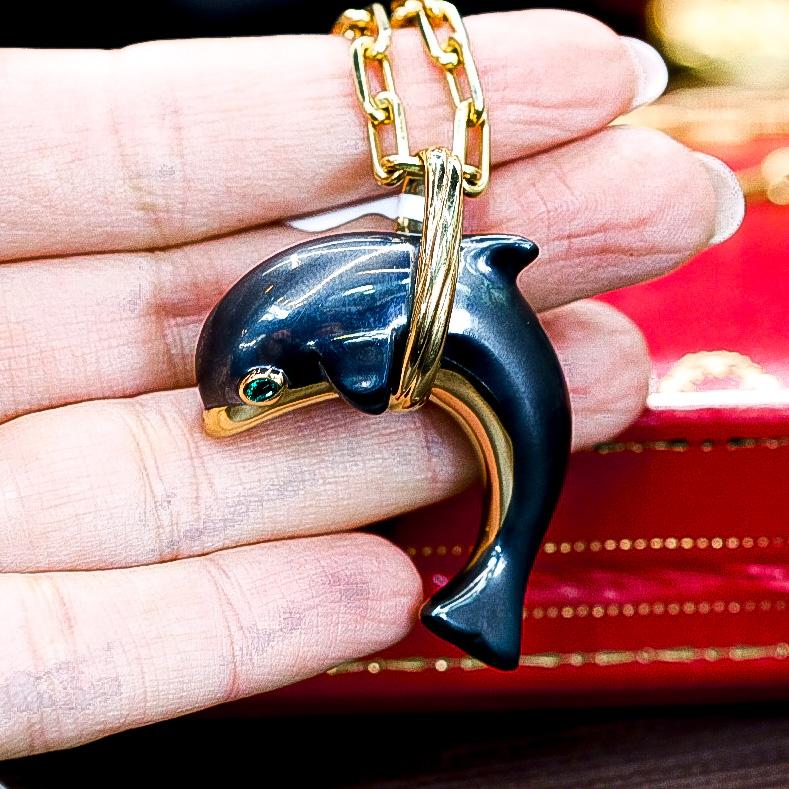 Cartier 18K Yellow Gold Hematite Dolphin Spartacus Chain Pendant.

A quirky hematite and 18k yellow gold Dolphin pendant by Cartier. The pendant features a Dolphin jumping through a hoop and is made up of hematite with yellow gold detailing. The