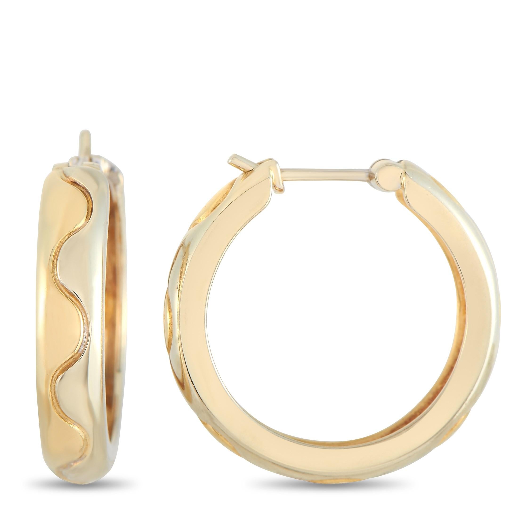 These Cartier 18K Yellow Gold Hoop Earrings are made with 18K Yellow Gold and feature a sort of zig-zag pattern around the hoop. The earrings measure 0.75 inches in length and 0.25 inches in width with each weighing 4.05 grams for a total weight of