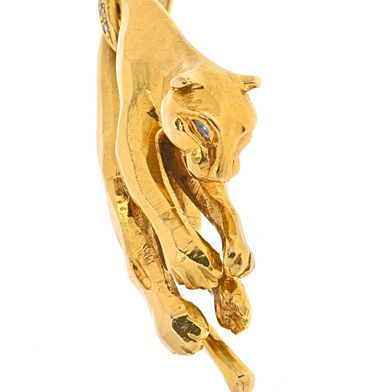 Cartier, the iconic and immortal Panthere pendant. Artfully and substantially sculpted in rich 18K gold with sparkling marquise diamond eyes, the sleek feline suspends from a Cartier diamond hinged loop, chain sold separately. A highly coveted,