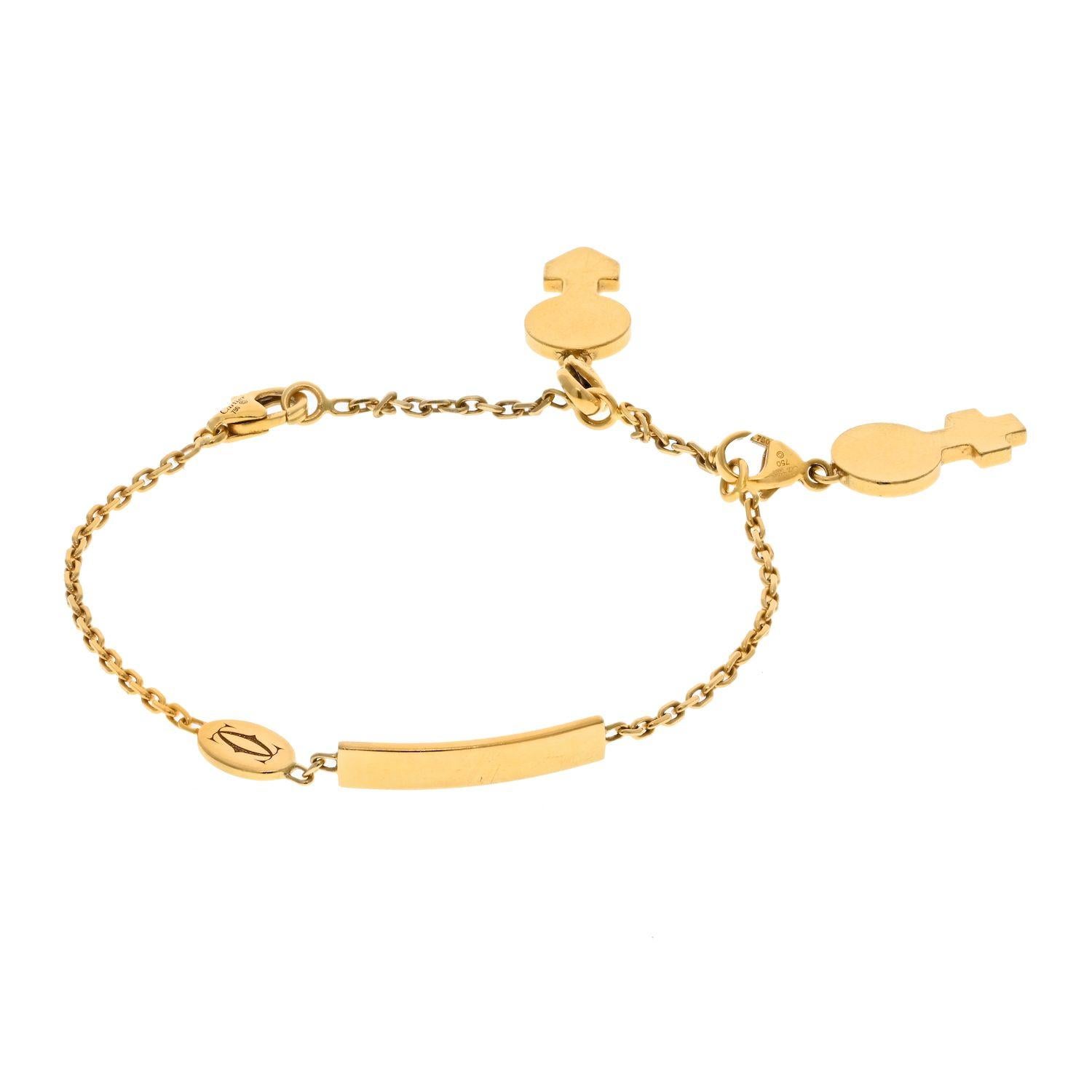 Beautiful and charming this is a vintage chain name ID plate bracelet by Cartier. Crafted in 18k yellow gold. This bracelet comes with two authentic Cartier charms (boy and girl). 
Bracelet measures: 6.5 inches (including the lock)
Plate: Length 0.7