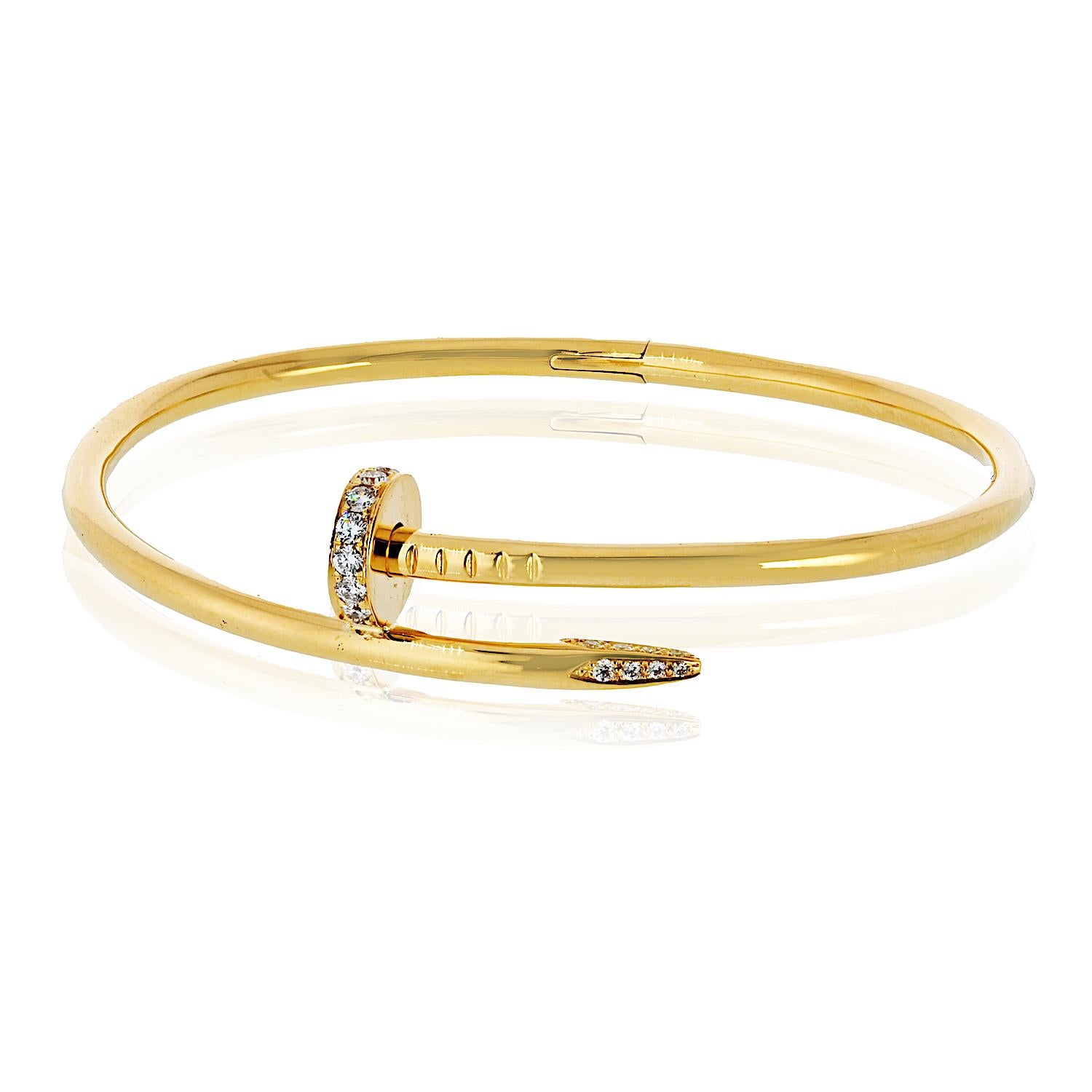 A striking Cartier Juste un Clou bracelet in 18K yellow gold, featuring round brilliant diamonds for added sparkle. This pre-owned piece is the classic size 21 model, showcasing the iconic nail design that blends industrial edge with timeless