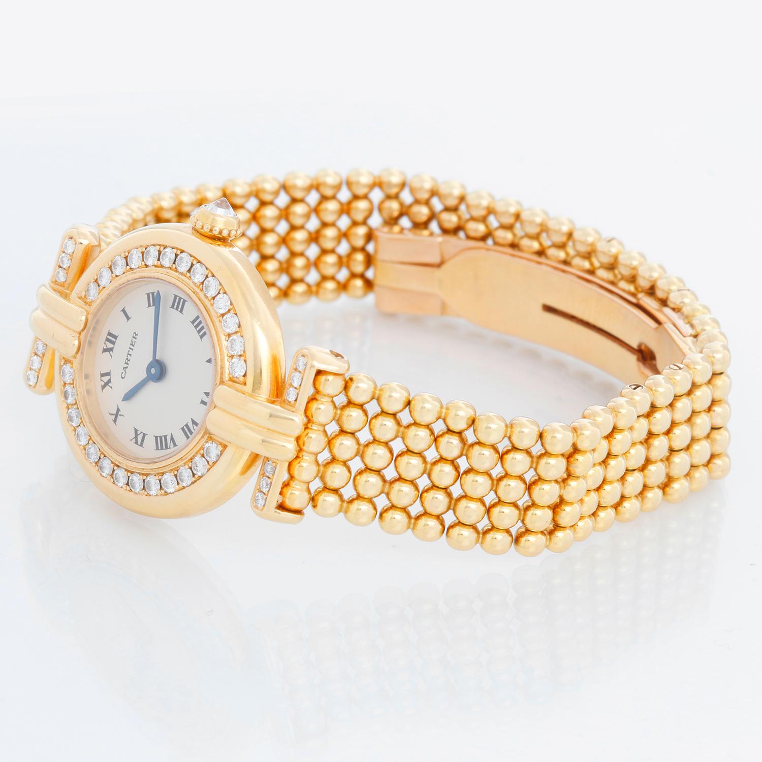 Cartier 18k Yellow Gold Ladies Colisee Diamond Watch - Quartz. 18k yellow gold case (24mm) with factory diamond bezel and lugs. Ivory dial with Roman numerals. 18k gold bead link Cartier bracelet with deployant; this will fit a 6 inch wrist .