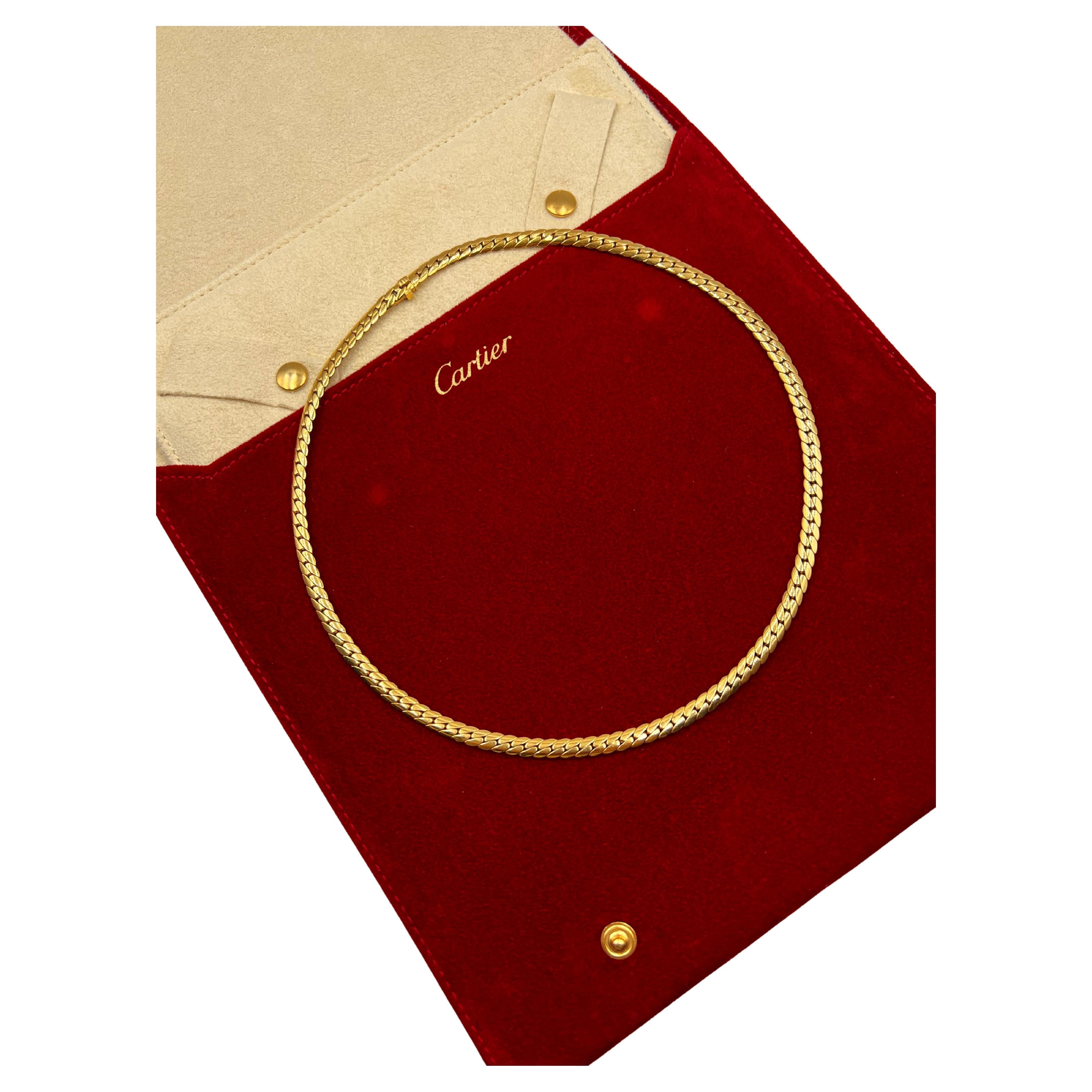 Cartier collar necklace, featuring a Cuban-style curb chain link in polished 18k yellow gold. Measuring 4.5mm in width and 17