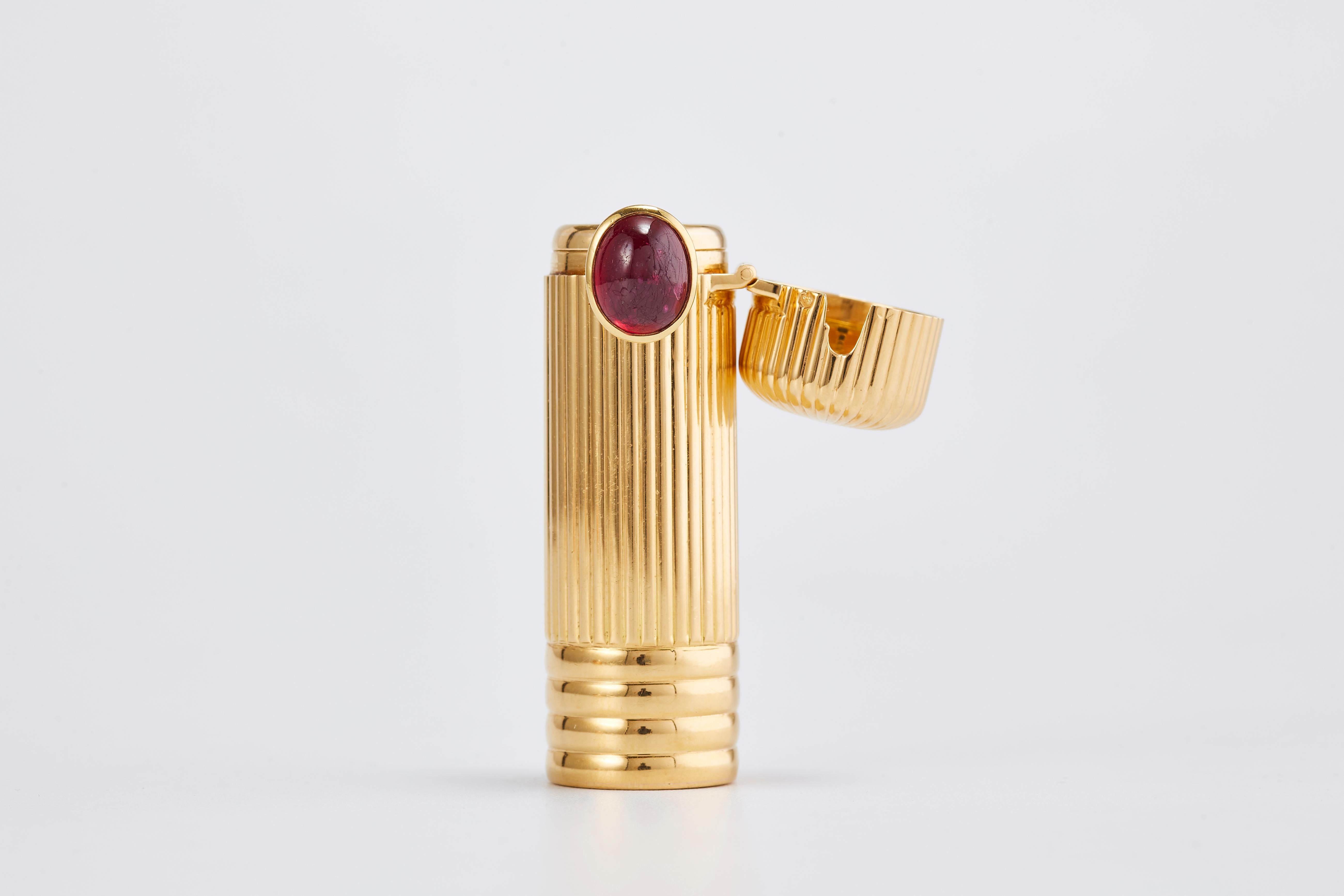 Cartier 18k Yellow Gold Lipstick container With Ruby

Very unique piece for a very unique person. 
From the 1950s, made in France.
Signed Cartier, with an oval Ruby of 5 carat, total weight: 37.5 grams.