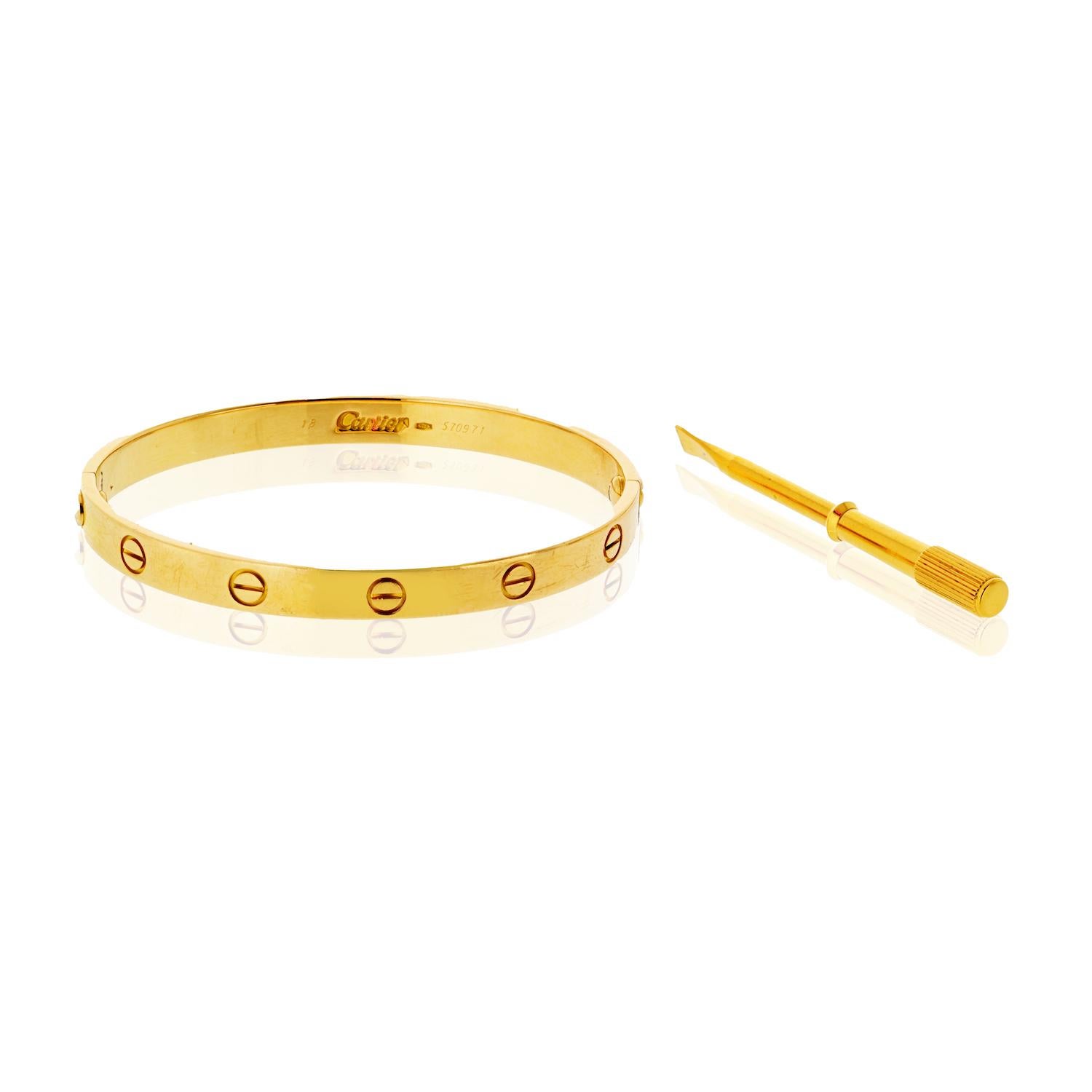 This pre-owned Cartier Love Bracelet is crafted from 18K yellow gold and comes complete with its original vintage box, screwdriver, and certificate, preserving its authenticity and charm. 

The iconic Love Bracelet design, known for its timeless