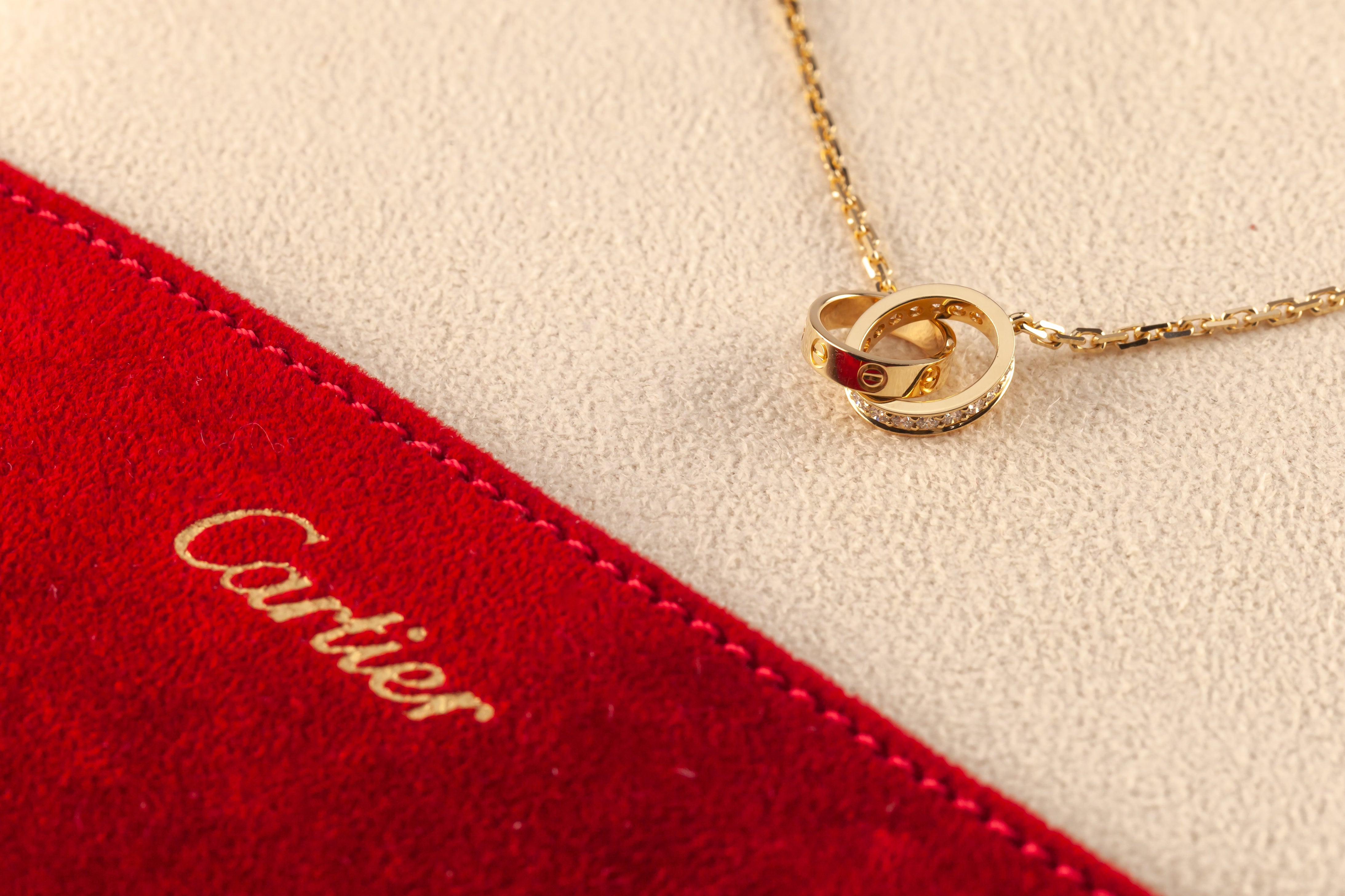Cartier 18k Yellow Gold Love Necklace w/ 0.22 cts Diamonds Original Pouch

Gorgeous Cartier Love Necklace
Features Two Interlocking Love Rings, One Set with Diamonds
Total Diamond Weight = 0.22 cts
Width: 2.65 mm
Inner Diameter: 7.6 mm
Chain Length:
