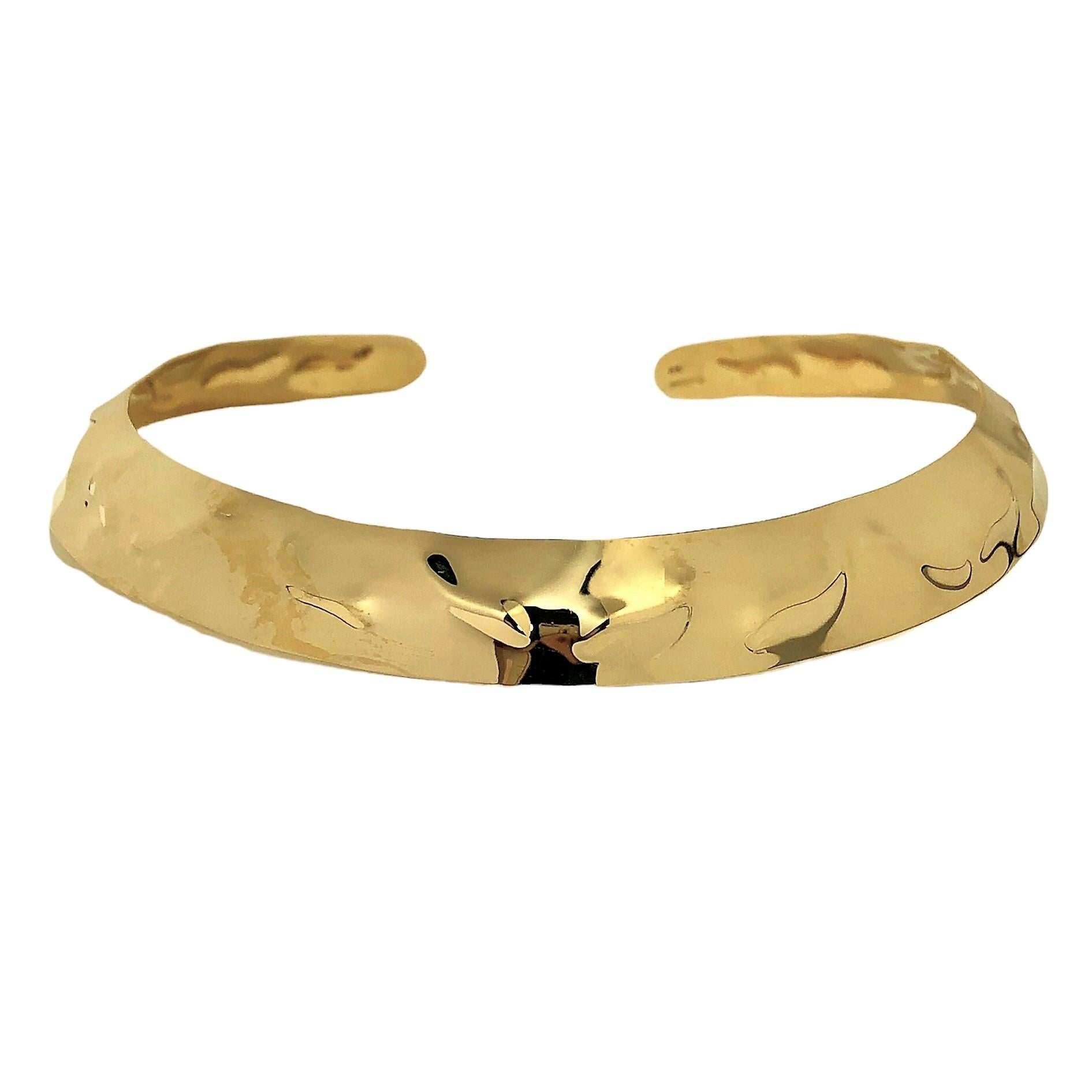 This striking Mid-20th Century Cartier 18k yellow gold choker is chased with repeating modernist motifs over it's entire surface.  Measures 5/8 inch in width at the front and tapers down to 7/16 inch at the rear. Markings are Cartier in script and