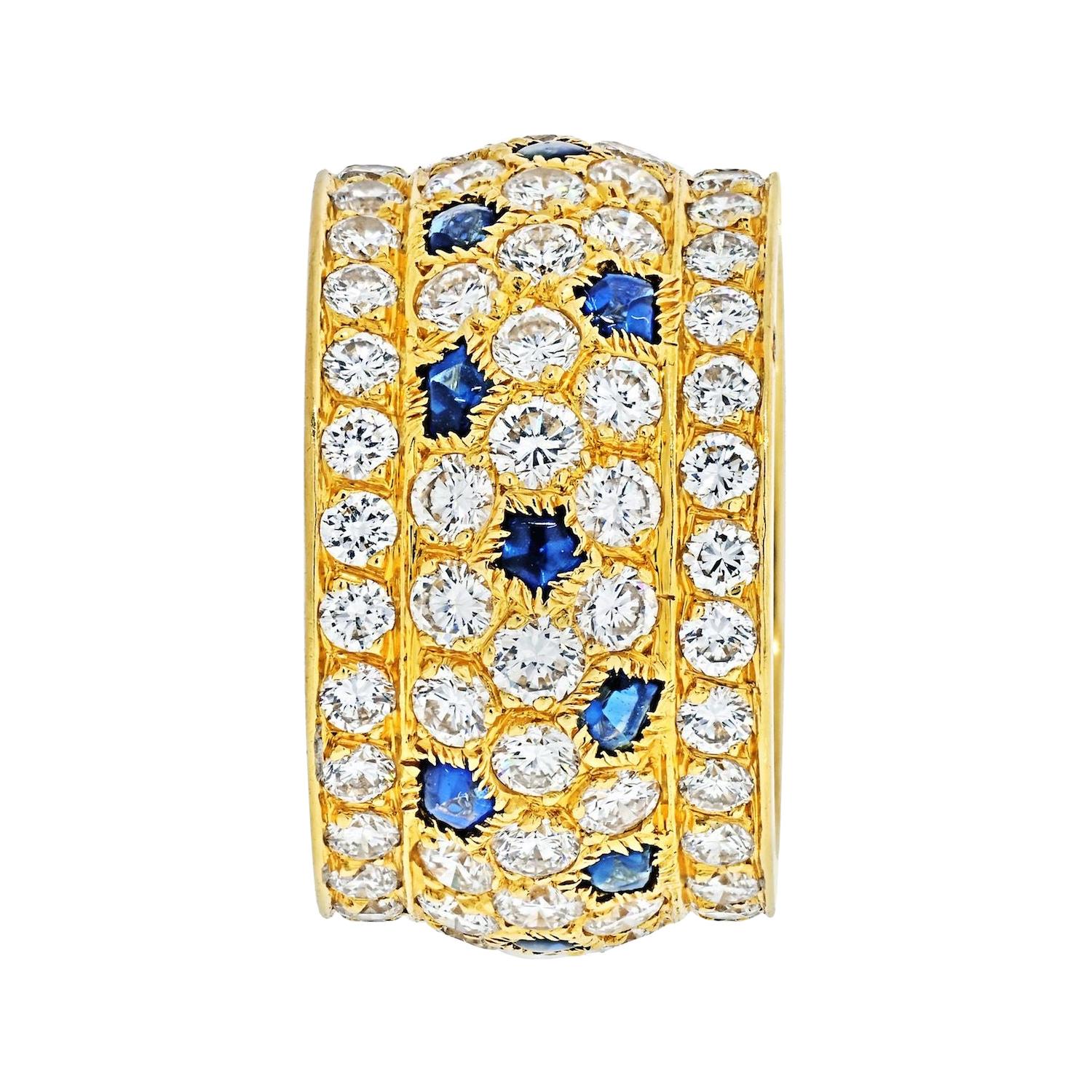 Cartier 18K Yellow Gold Nigeria Diamond Sapphire Ring.
Diamond and sapphire 'Nigeria' ring, Cartier, France. 
The band ring set with round diamonds weighing approximately 5.60 carats, with buff-top sapphire accents, 
Ring size is 6.5.
European size