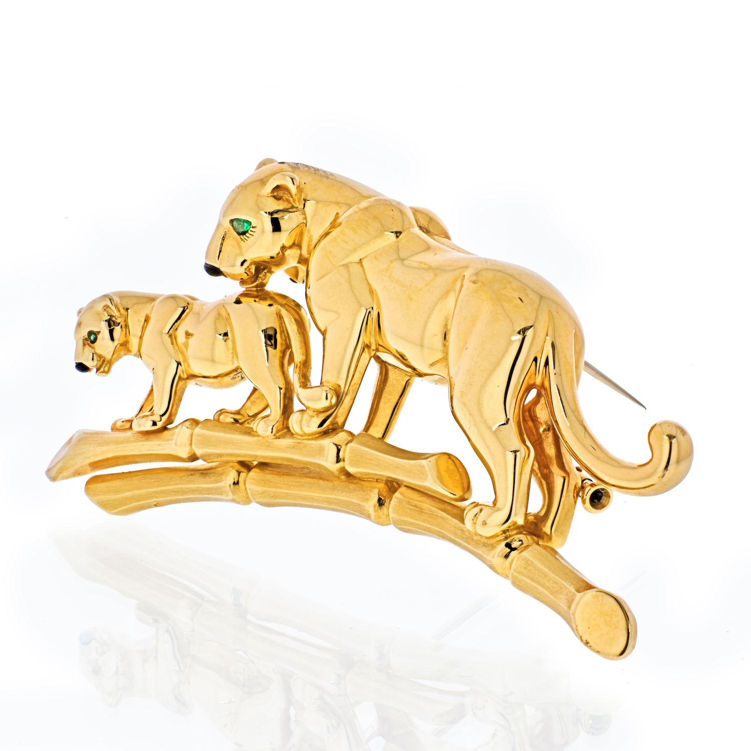 This is an impressive Cartier Mother and Child Panthere Brooch pin in solid 18k yellow gold set with genuine emerald eyes. We love that this brooch has a significant weight to it, yet is not too large for everyday wear. 
It is in impeccable
