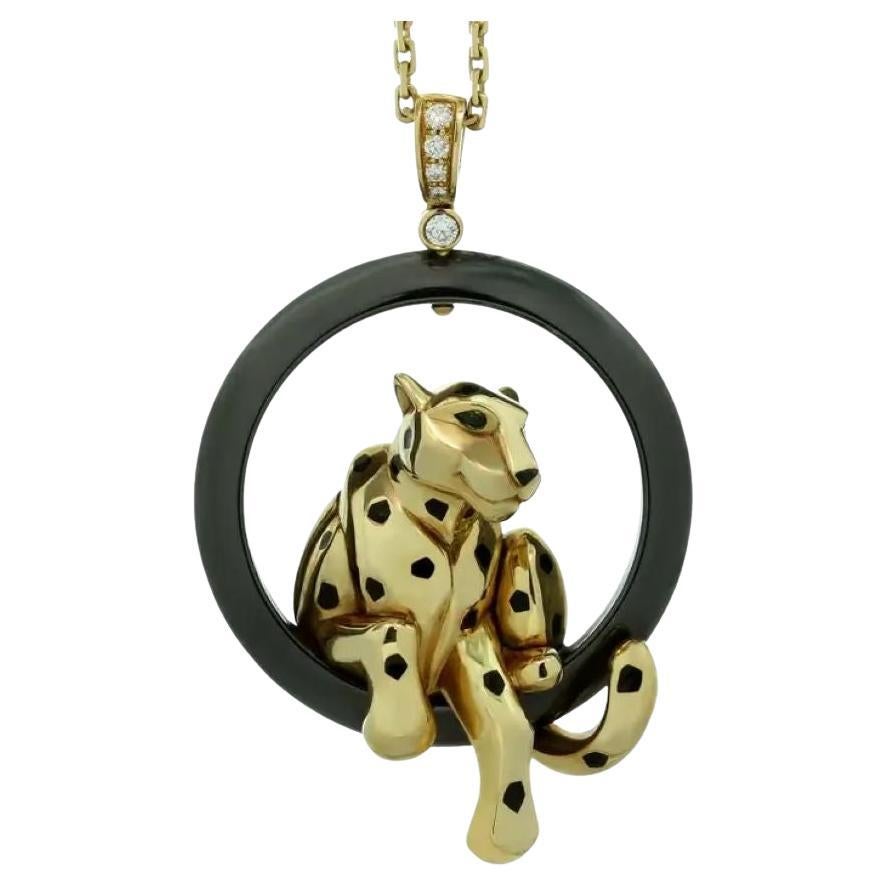 The pendant features a mesmerizing panther, gracefully perched on a ceramic ring, adorned with black lacquer spots that add a touch of drama to the design. The panther's onyx nose and piercing tsavorite garnet eyes beautifully contrast against the