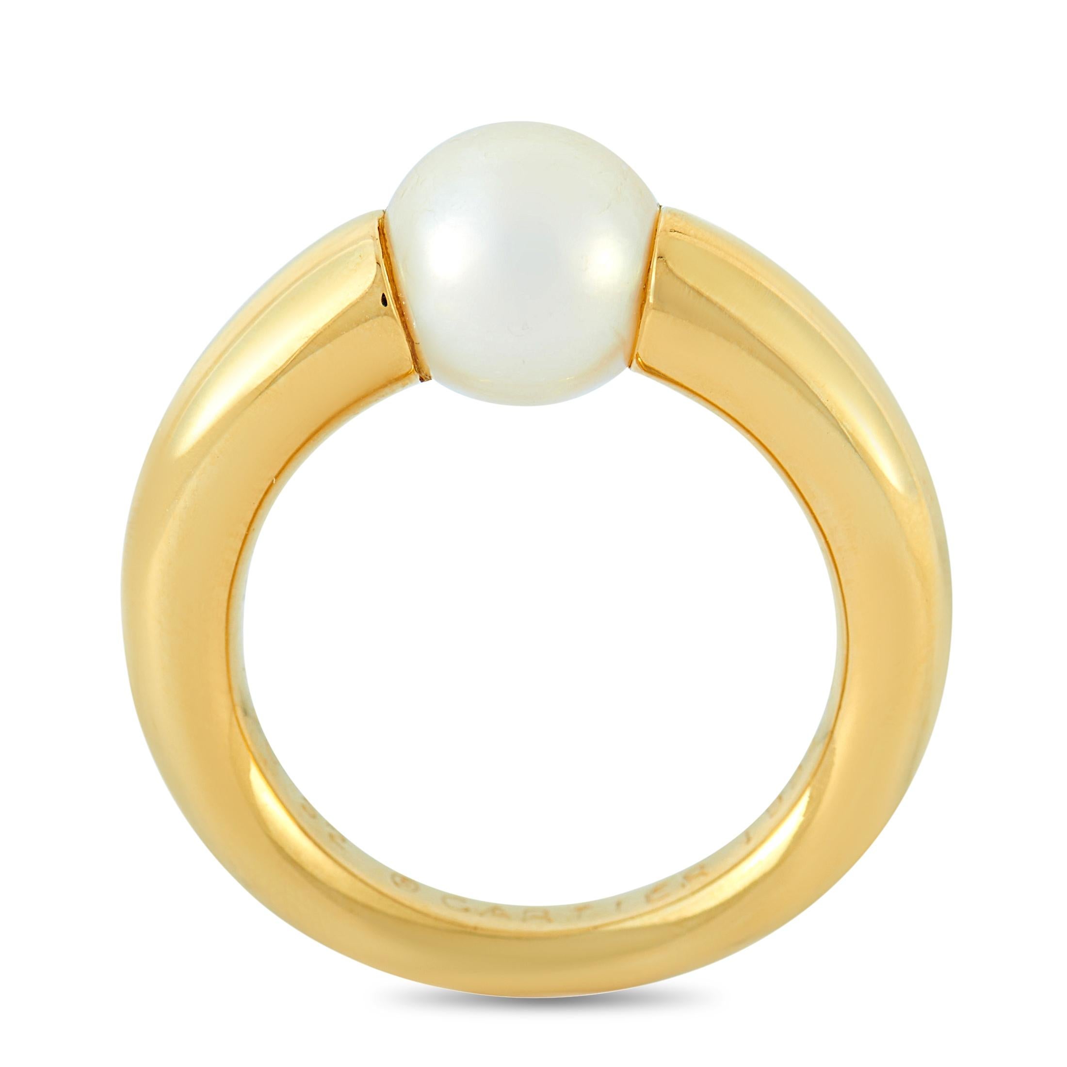 This Cartier ring is made of 18K yellow gold and embellished with a pearl. The ring weighs 11 grams and boasts band thickness of 3 mm and top height of 7 mm, while top dimensions measure 7 by 7 mm.
 
 Offered in estate condition, this jewelry piece