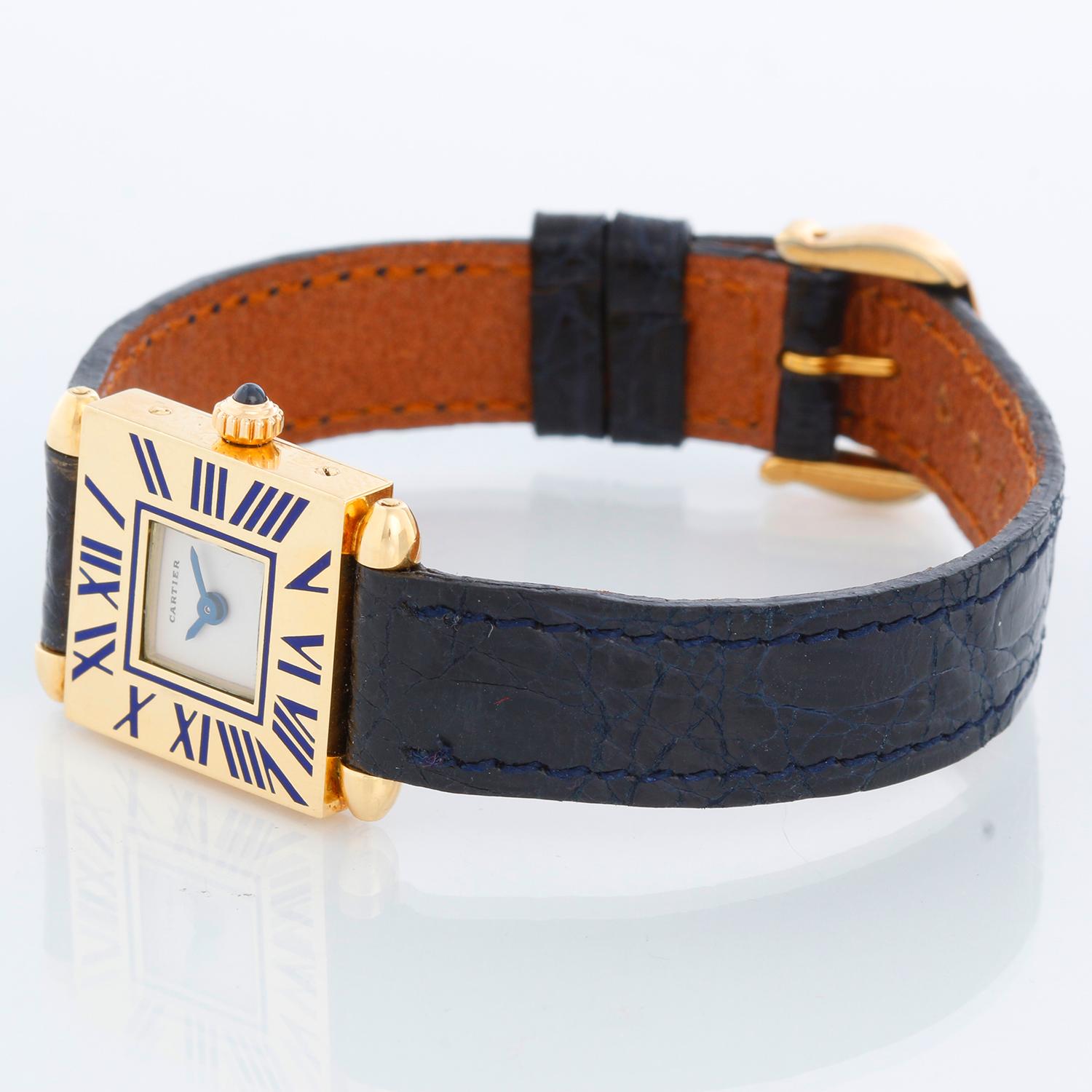 Cartier 18k Yellow Gold Quadrant Ladies Watch - Quartz. 18K Yellow gold ( 19 mm x 26mm ) grained blue Roman numerals. Ivory dial with blue hands. Black Cartier strap with Cartier tang buckle . Pre-owned with custom box.