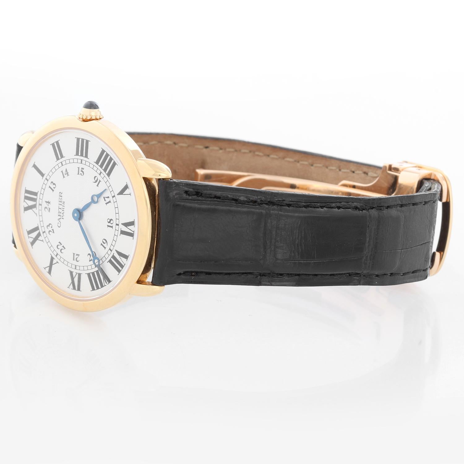 Cartier 18K Yellow Gold Ronde Louis Ladies Watch  - Manual winding. 18K Yellow Gold case ( 33 mm). Guilloche dial with Roman numerals and Arabic numerals. Black Cartier strap with Cartier yellow gold deployant clasp. Pre-owned with Cartier box.