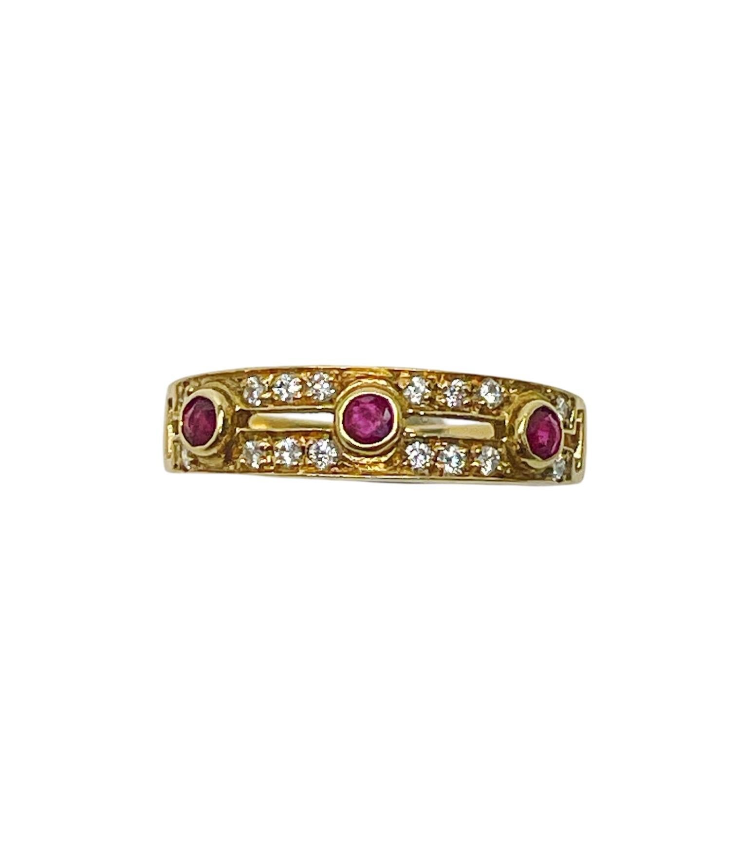 This classic Cartier ring contains three round mixed cut rubies measuring approximately 2.40 mm in diameter surrounded by two rows of round brilliant cut diamonds weighing approximately 0.27 carat total.

Stamp: Cartier 18KT 647. 
Ring Size: 6