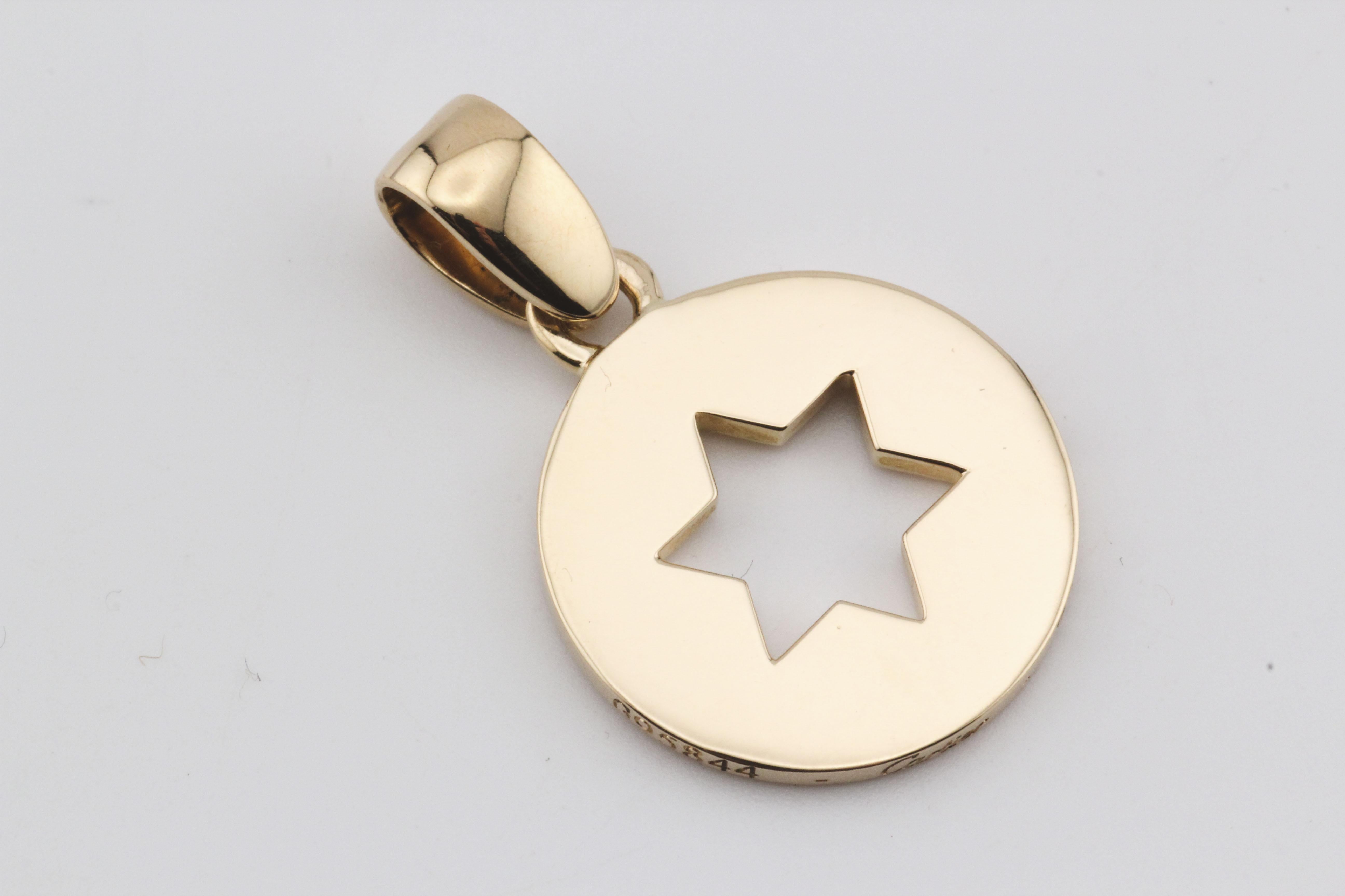 The Cartier 18K Yellow Gold Star of David Charm Pendant is a beautifully crafted piece that combines simplicity with deep cultural significance. This round charm is made from luxurious 18k yellow gold, exuding a warm, radiant glow that highlights
