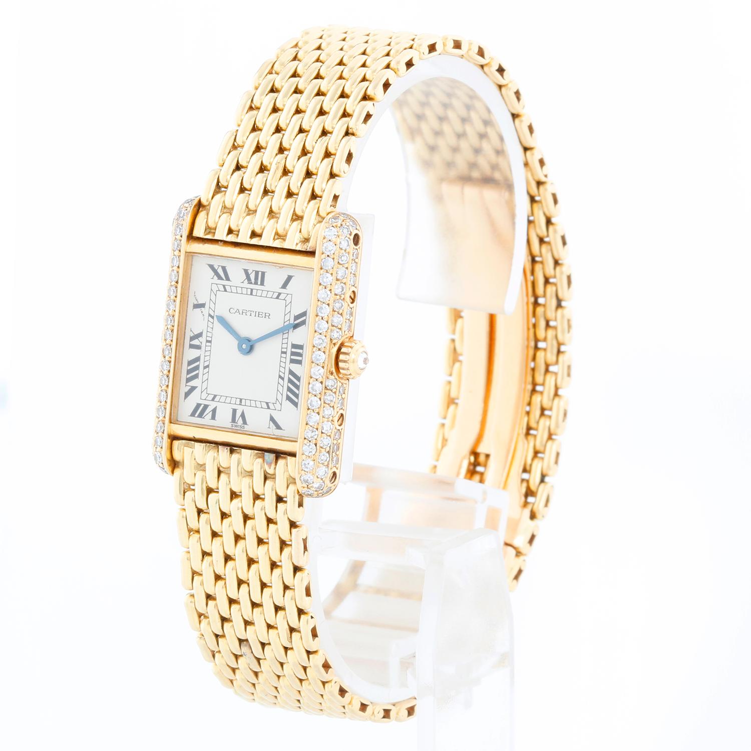 Cartier 18K Yellow Gold Tank Ladies Watch - Quartz. 18K yellow gold with diamond case ( 21 x 28 mm ). Silver tone dial with black roman numerals. Rice link bracelet with deployant clasp; will fit a 7 inch wrist. Pre-owned with Cartier box.