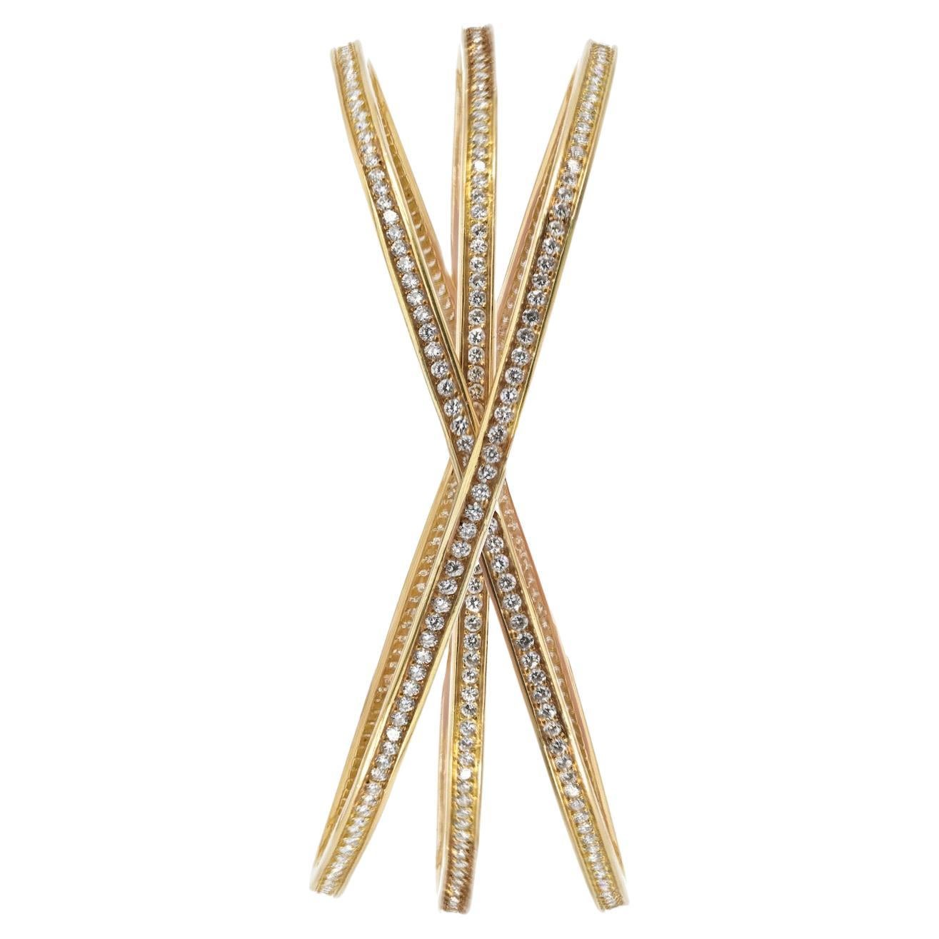 Bracelet à glissière en or jaune 18K et diamants trinitaires de Cartier. Cette pièce emblématique associe harmonieusement le célèbre Design/One de Cartier à l'éclat de diamants taille ronde totalisant 6,50 carats. Chaque diamant est méticuleusement