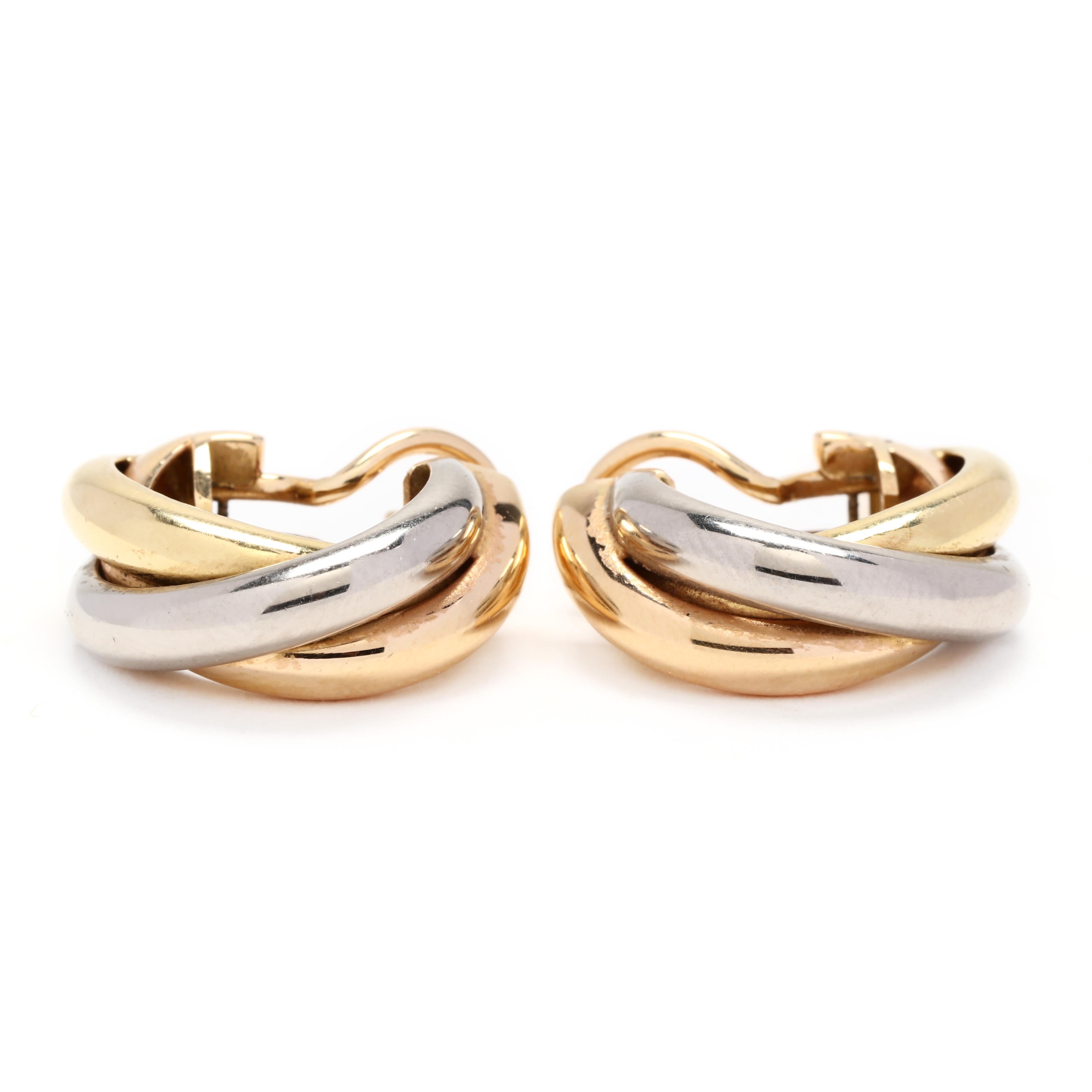 18k yellow, white and rose gold Cartier hoop earrings. Classic tricolor hoops that twist by the famous jewelry house Cartier. As a shrimp style they have a post and leverback for easy on and off and security. A timeless addition to any