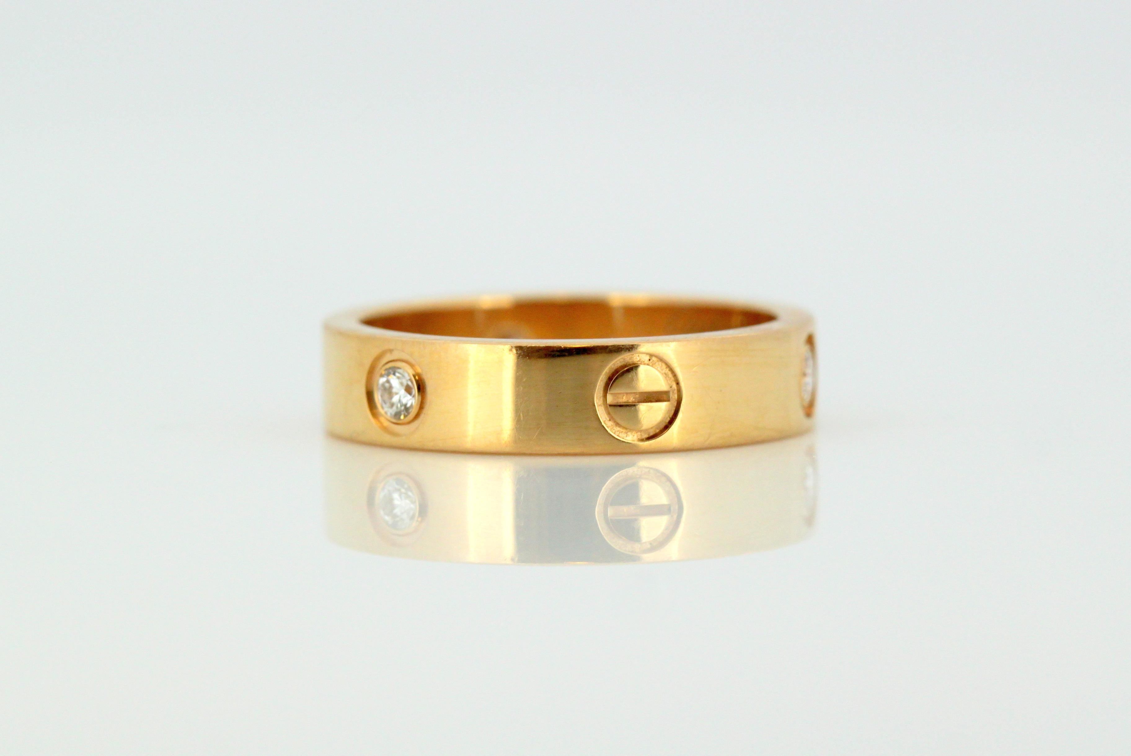 Cartier 18kt gold love ring with diamonds.
Designer: Cartier
Made in France, Paris circa 1990's
Fully hallmarked.

Dimension - 
Diameter x Width : 2.4 x 0.5 cm
Finger Size : (UK) = V(US) = 10 3/4 (EU) = 63 3/4
Weight : 10 grams

Diamonds - 
Cut :