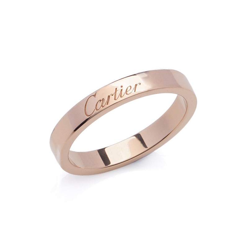 Cartier 18kt. rose gold band ring. 
Designer: Cartier
Made in France, 2000's
Fully hallmarked.
Comes in the original box and outer box.

Dimensions -
Finger Size (UK) = L US) = 6 1/2 (EU) = 52 
Size: Diameter x height: 1.9 x 0.2 cm 
Weight: 4.00