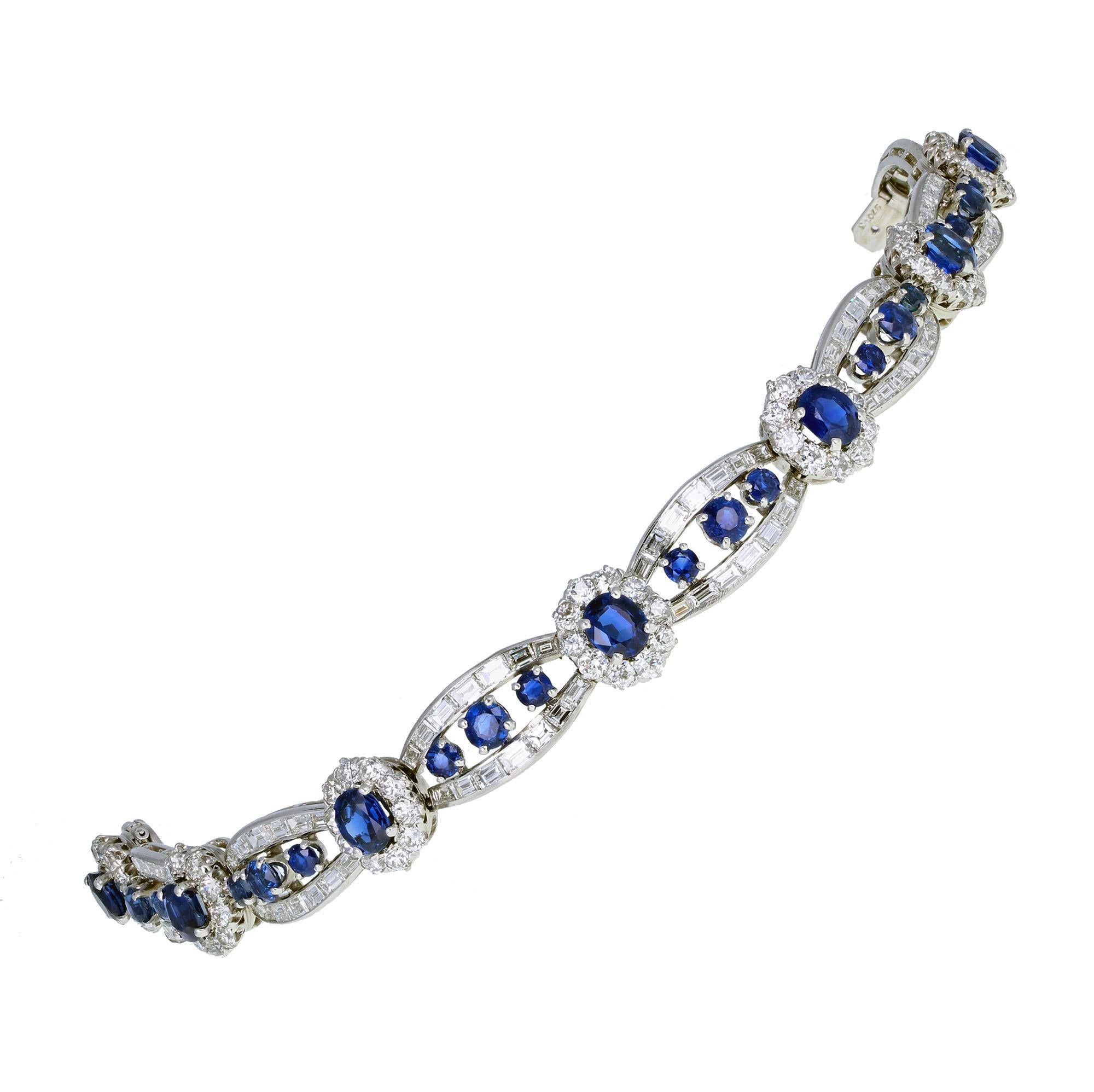 An exquisite platinum sapphire and diamond bracelet from the 1920s from the famed house of Cartier. Seven oval sapphire and diamond clusters, joined with a double row of channel-set, baguette-cut diamonds and three round-cut sapphires. A beautiful,