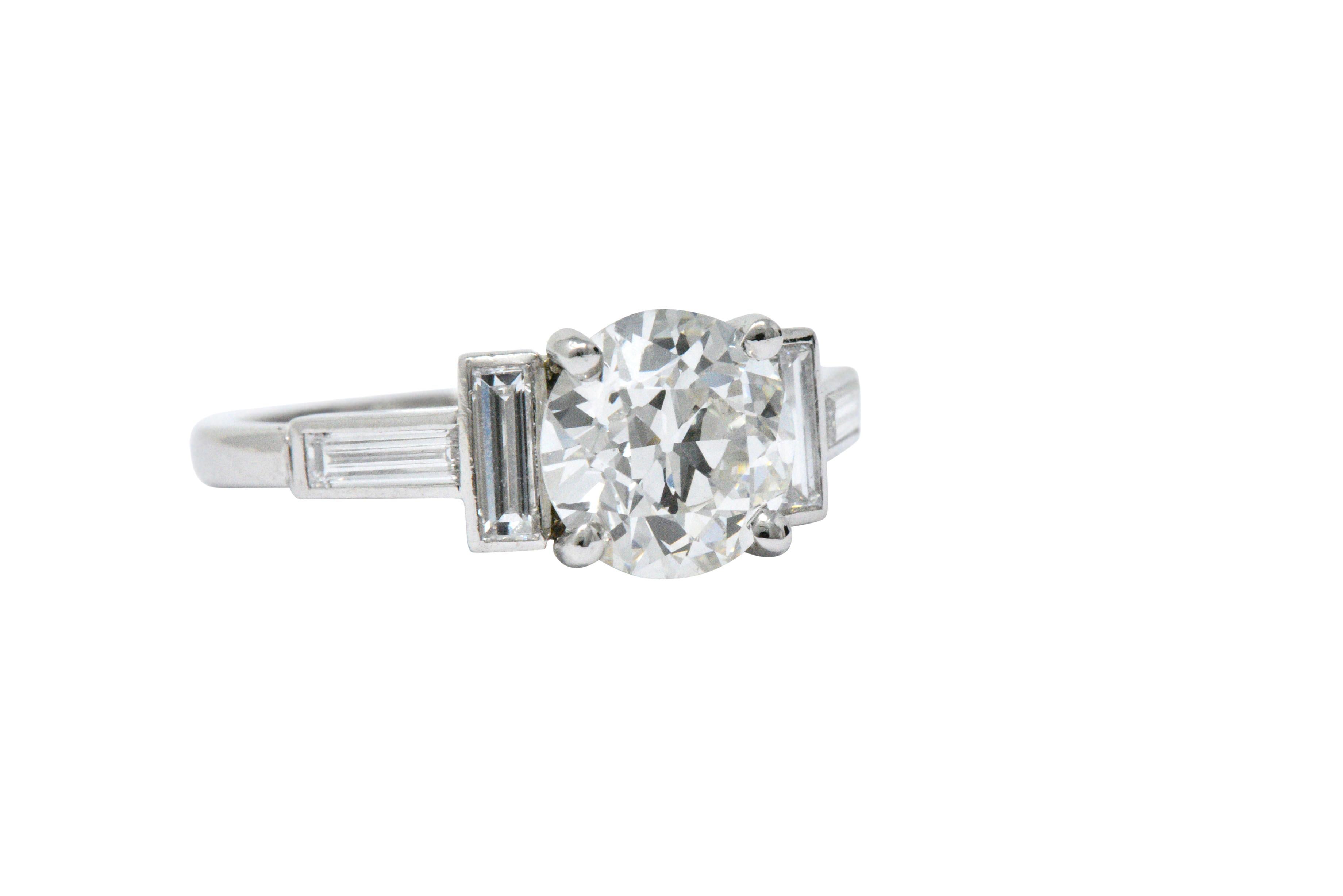 Centering a circular brilliant cut diamond weighing 1.62 carats, I color and VS2 clarity

Flanked by baguette cut diamonds, weighing approximately 0.40 carats total, G/H color and VS clarity

Fully signed Cartier on the side of the shank, numbered