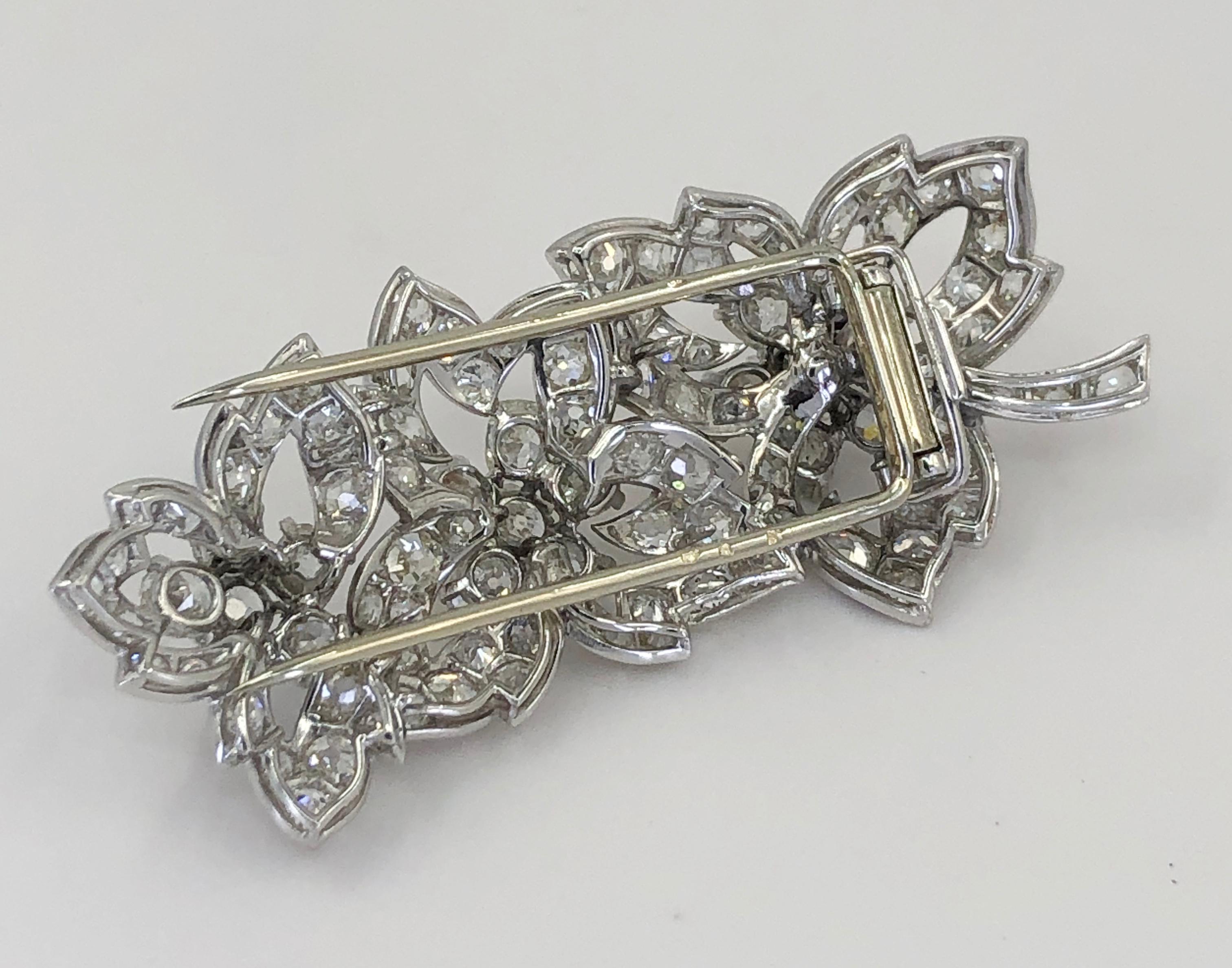 Cartier Paris Vintage 1950s Diamond Stylized Floral Pin

A fine signed “Cartier”; circa 1950s platinum brooch, designed as three leaves, set with cushion-shaped and round diamonds.
Large diamond weight is approx. 1.0 ct. G-H VS and the total diamond