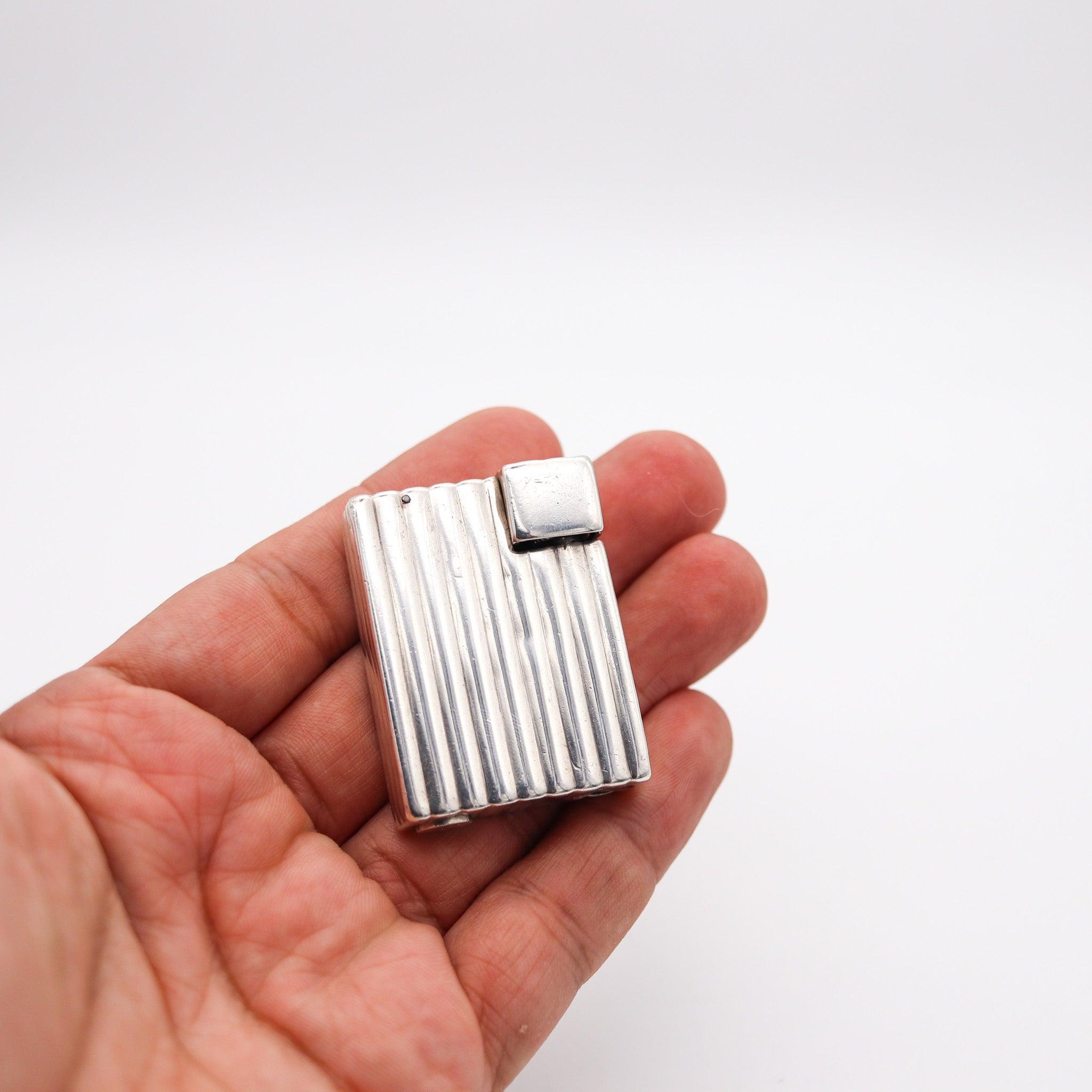 An art deco lighter designed by Cartier.

This is a beautiful petrol pocket lighter, created in Paris France by the atelier-Frontin for the jewelry house of Cartier, back in the 1935. The lighter has been crafted with rectangular and squared linear
