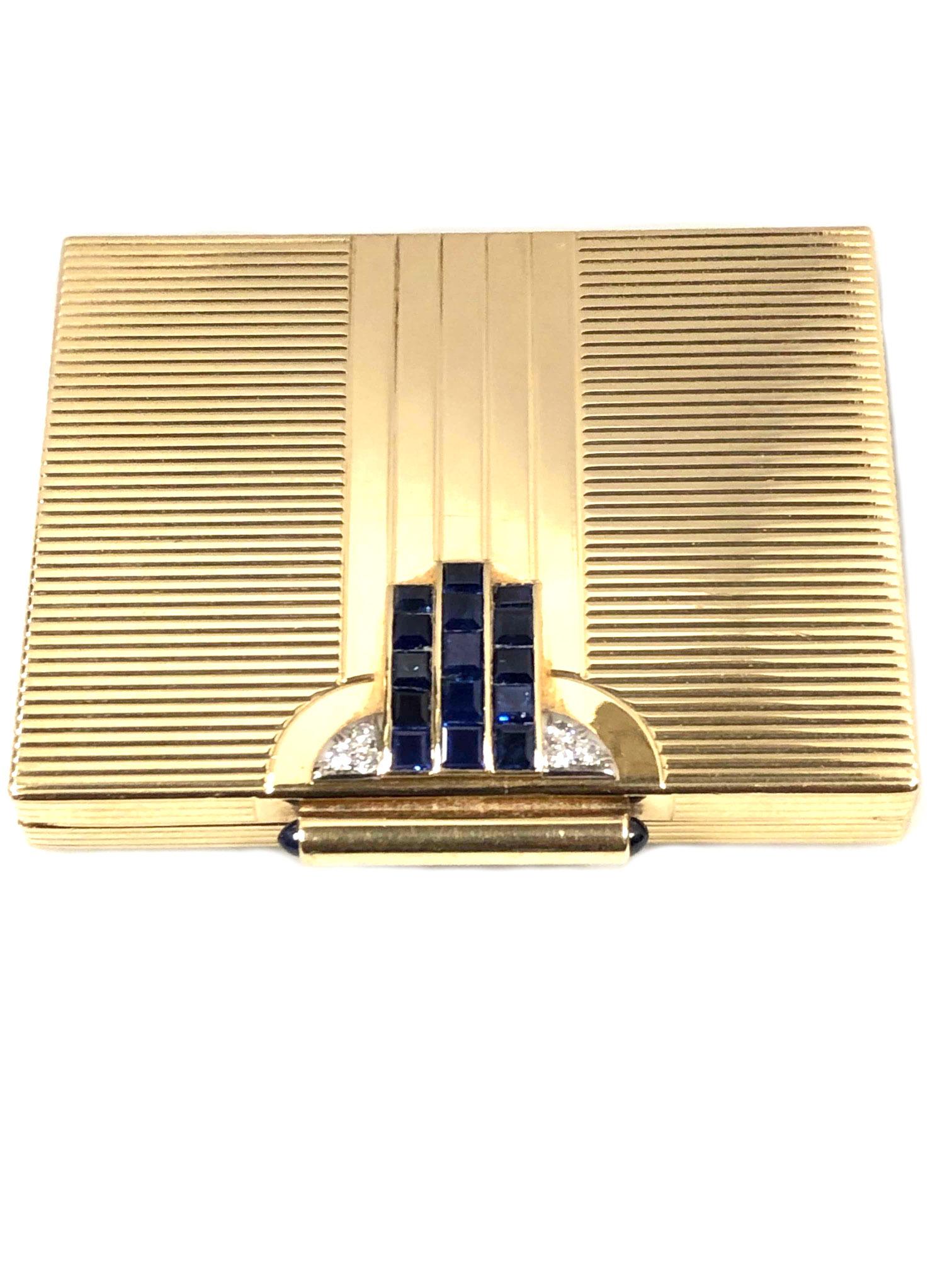 Circa 1940s Cartier Compact, 14K Yellow Gold and Having A Strong Art Deco design, measuring 2 3/4 X 2 1/4 X 3/8  inch. Vertical and Horizontal lines and set with Very Fine Color Square, Step Cut Natural Sapphires, Cabochon Sapphires on the Clasp and