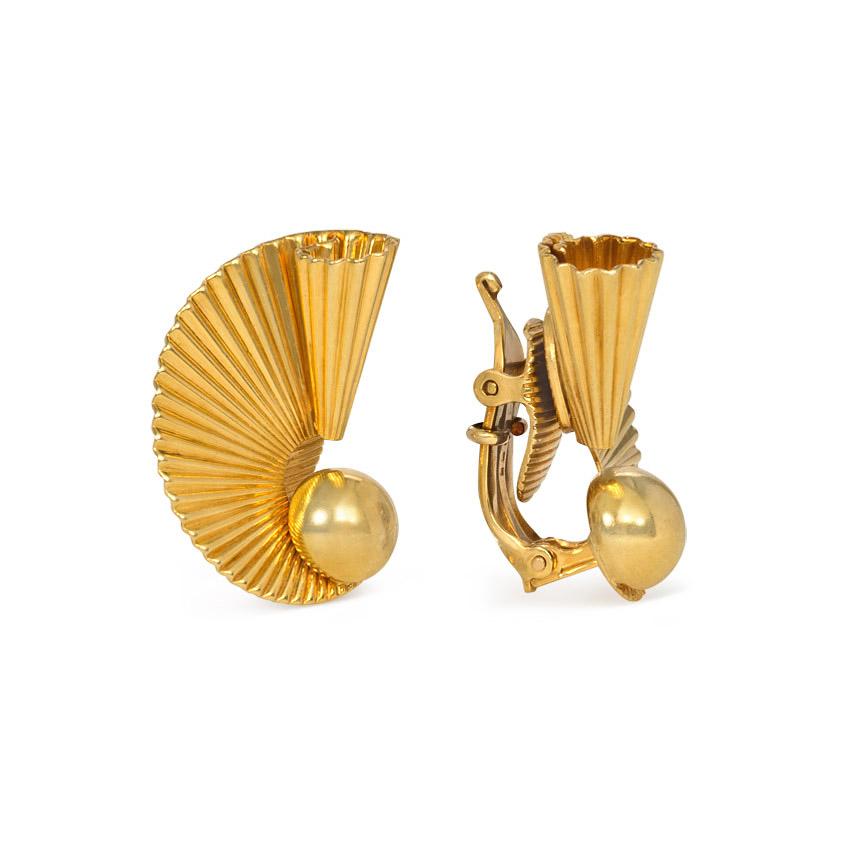 A pair of Retro gold clip earrings of scrolled and fluted design with a bead center, in 18k. Cartier, #12860