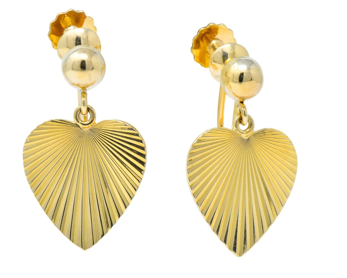 Each designed as a polished ball surmount with a heart drop featuring a radiating motif

Polished faceted finish

Completed by screw-backs

Fully signed Cartier and numbered

Stamped 14k for 14 karat gold

Circa 1940's

Measures: 5/8 x 1 inch

Total