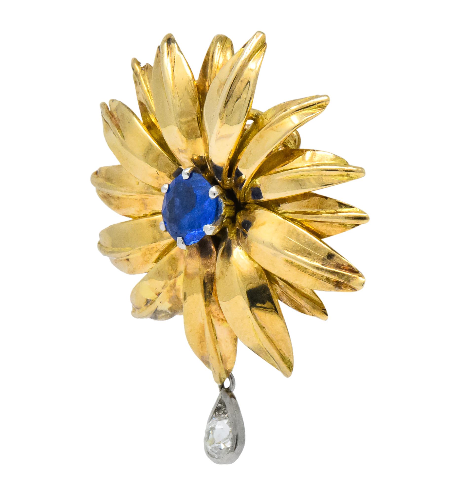 Earrings designed as flowers with radiating polished gold petals suspending an articulated old mine cut diamond drop weighing approximately 0.30 carat total; eye-clean and white

Each flower centers a round cut Burmese sapphire weighing in total