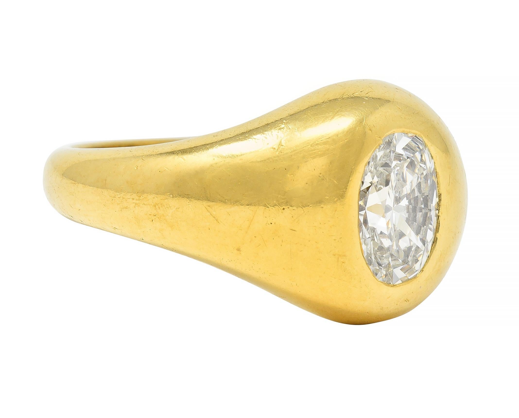 Centering an oval cut diamond weighing approximately 1.22 carats - F color with VS2 clarity
Flush set with a sinuous oval-shaped face surround 
With rounded shoulders and profile 
Tested as 18 karat gold 
Numbered and fully signed for Cartier
Circa: