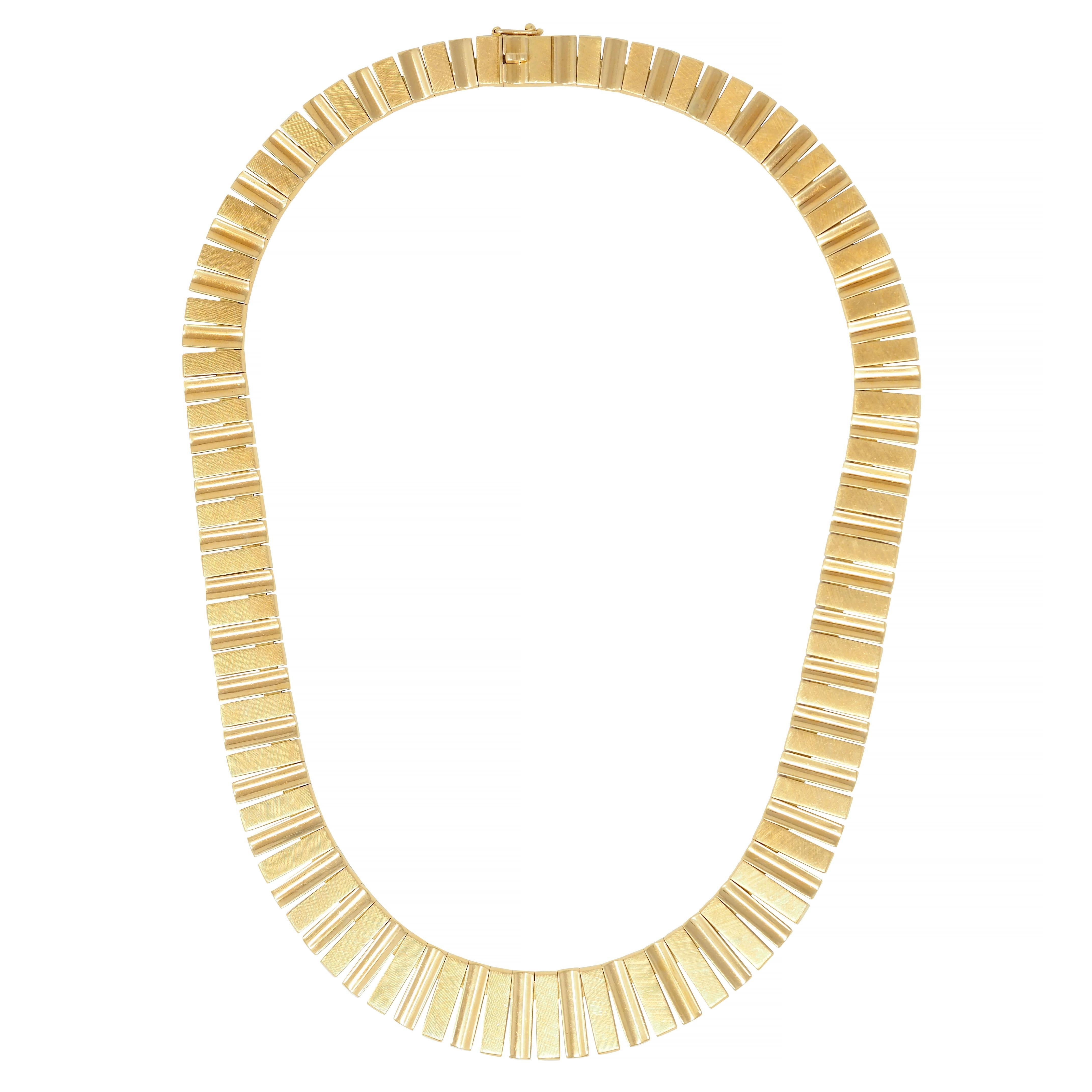 Comprised of graduated yellow gold rectangular-shaped links 
With alternating concave and flat tops creating a wave motif 
Concave links are high polished while flat links are textured
Engraved with a linear cross-hatch motif 
Completed by concealed