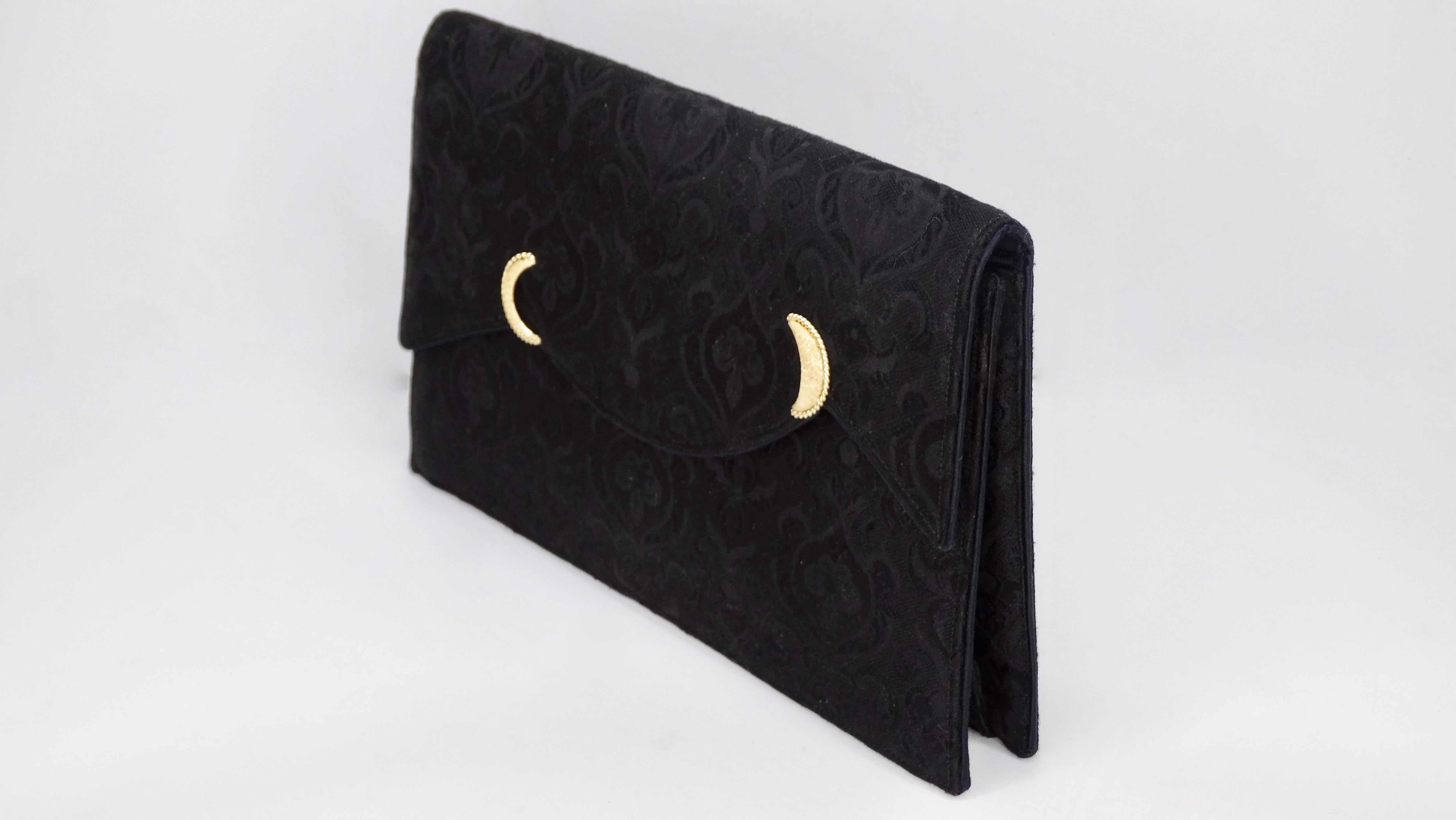 Add some elegance to your look with this amazing Cartier evening clutch! Circa 1960s, this clutch features a vintage fleur de lis pattern with an asymmetrical front flap decorated with two crescent moon shapes. Snap button closure opens up to a