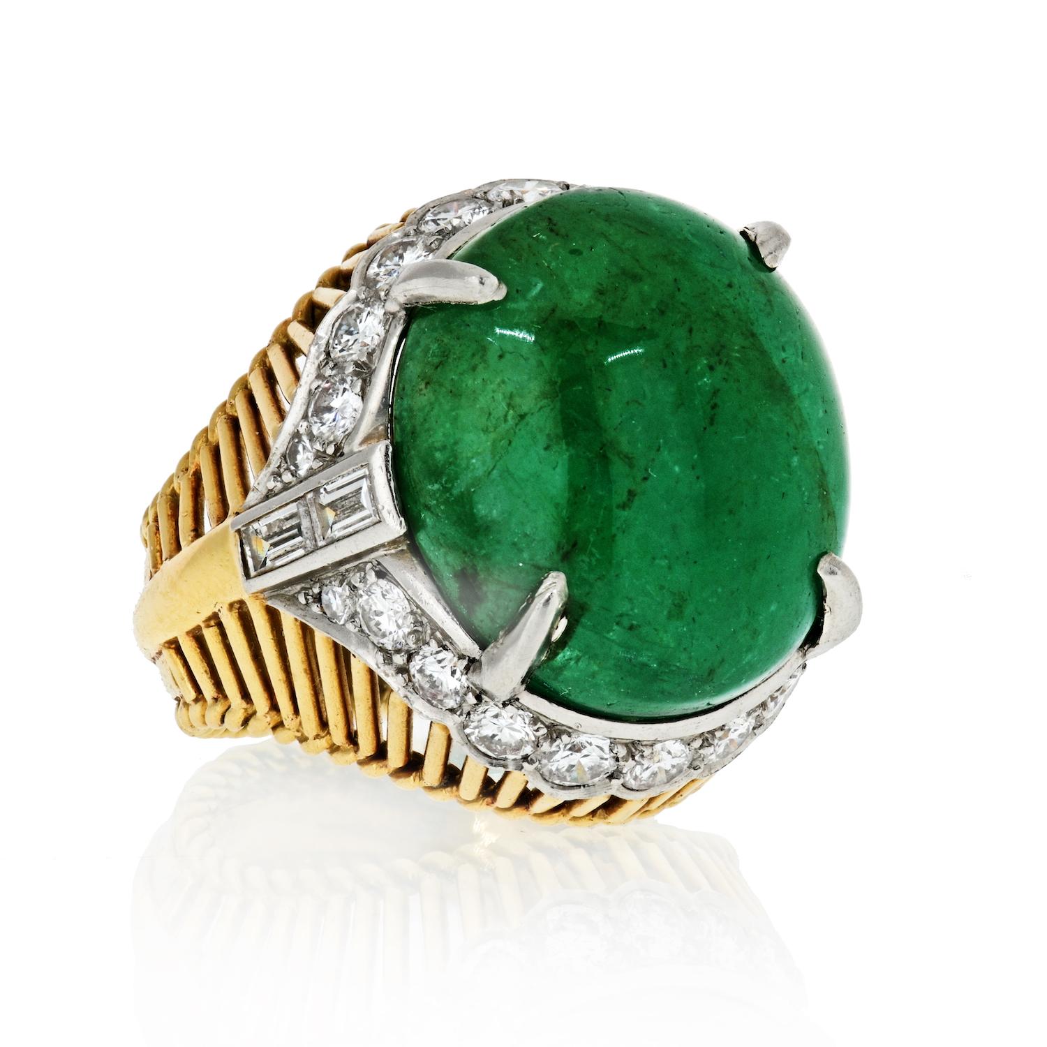 Questions? Call us anytime!
The Back Vault NYC.
833,998,2858

This Cartier 1960's cocktail ring features a 15-carat green cabochon-cut emerald with .65 carats of round and baguette diamond accents and is set in 18 karat yellow gold and platinum.