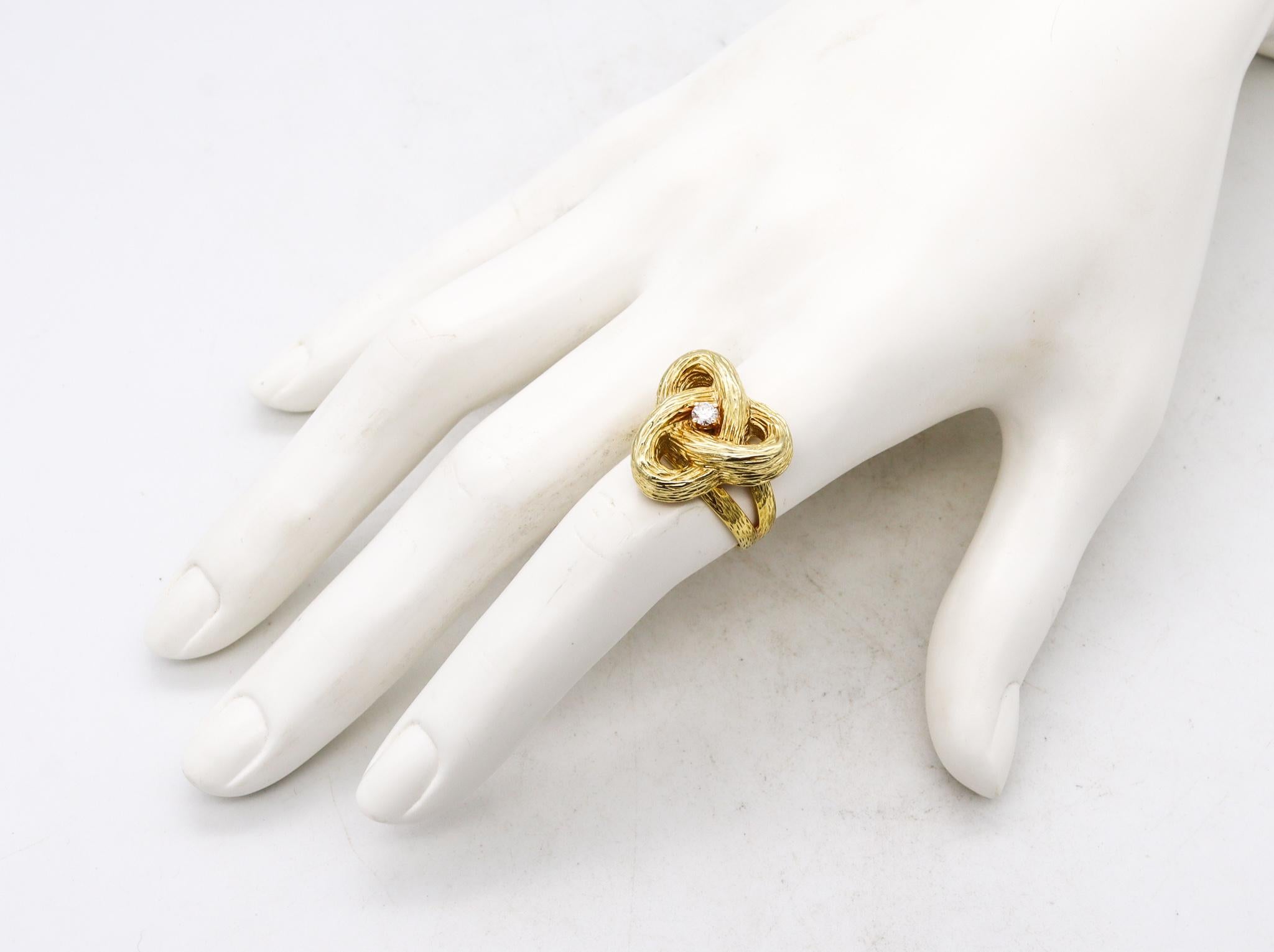 A Celtic ring designed by Cartier.

Very interesting piece created by the house of Cartier during the Spazialism period, circa1960's. It was carefully crafted in solid yellow gold of 18 karats, with textured finish. Featuring as a main decorative