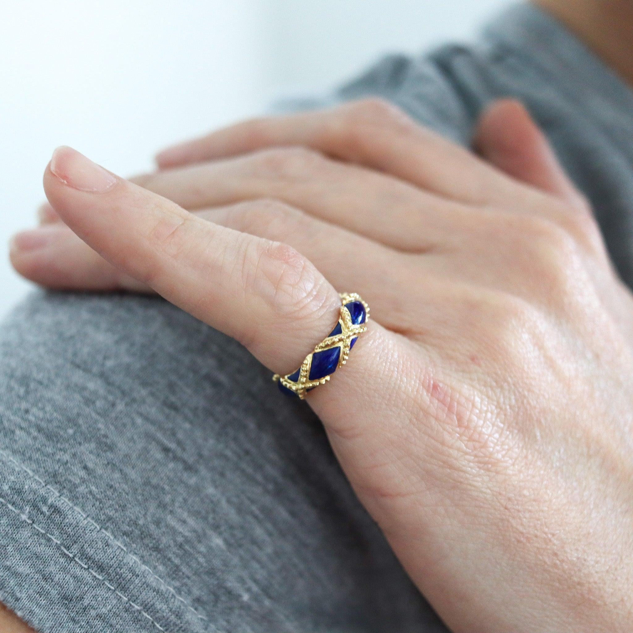 A blue enameled ring designed by Cartier.

This is a beautiful modernist ring, created by the jewelry house of Cartier, back in 1970. The ring has been carefully crafted in solid yellow gold of 18 karats with textured finish. Embellished with