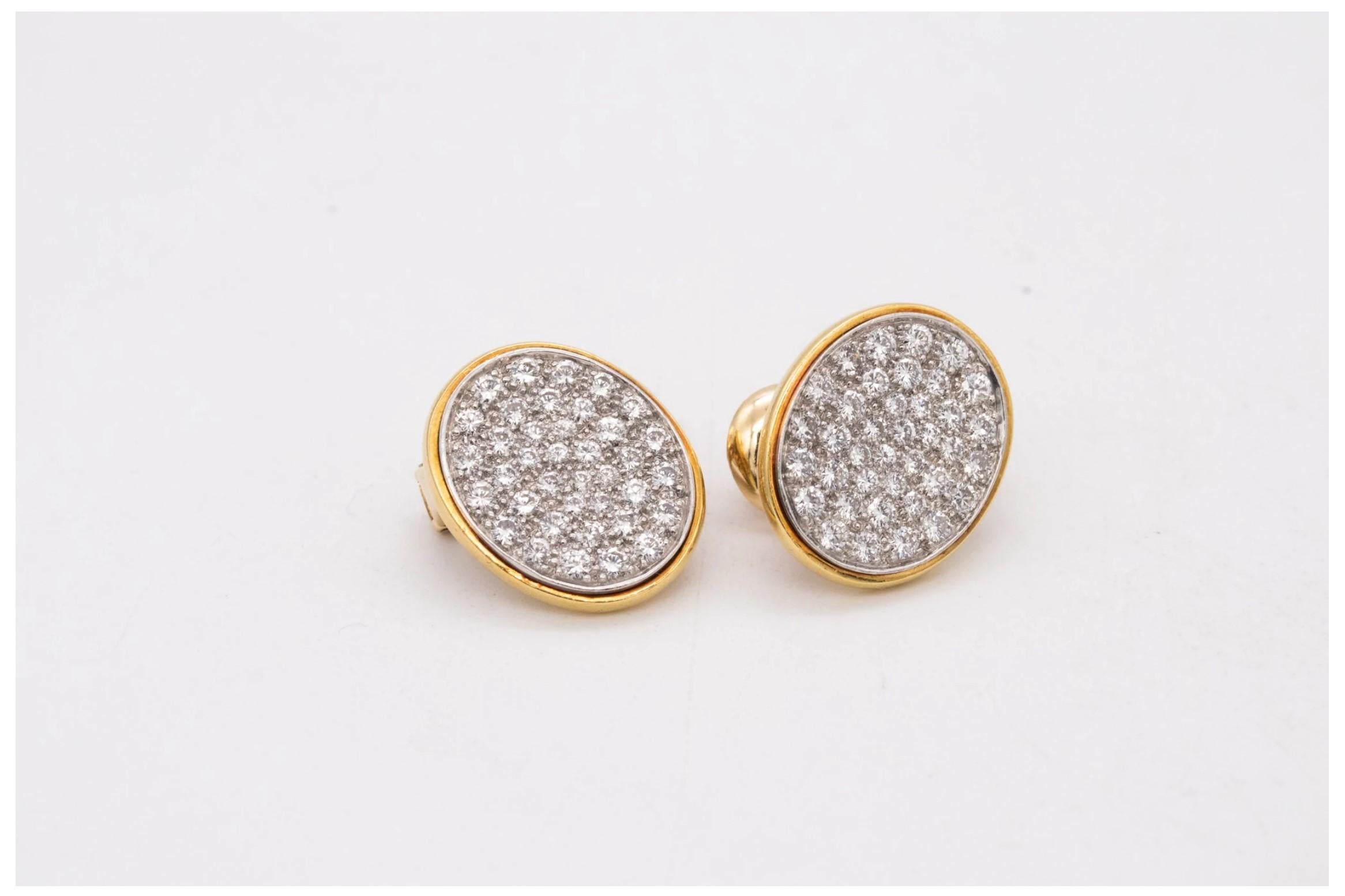 Oval shaped earrings designed by Dinh Van for Cartier.

Very rare vintage pieces made in Paris, France at the end of the 1960's. This earrings was crafted in 18 karats yellow gold and .900/.999 platinum. They are suited at the reverse, with