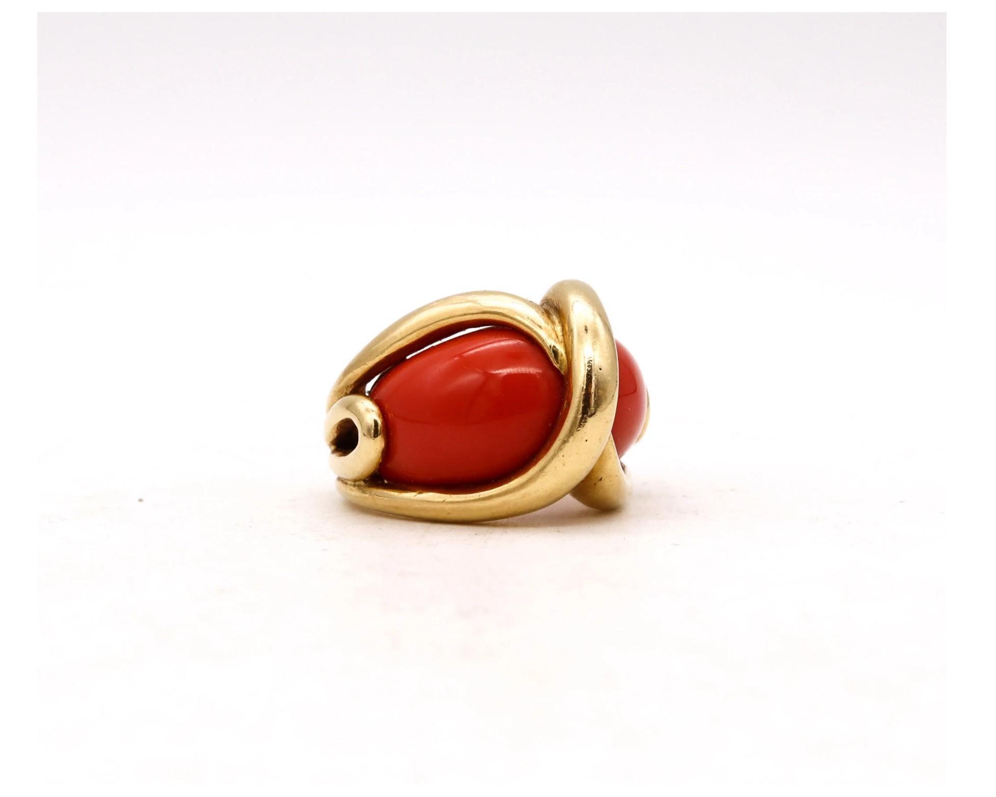 Rare cocktail ring designed by Cartier.

A beautiful, modernist and elegant piece created by Cartier in Paris France circa 1970's. This sleek semi bombe ring was crafted in solid 18 karats yellow gold and is embellished, with a pair of cabochons