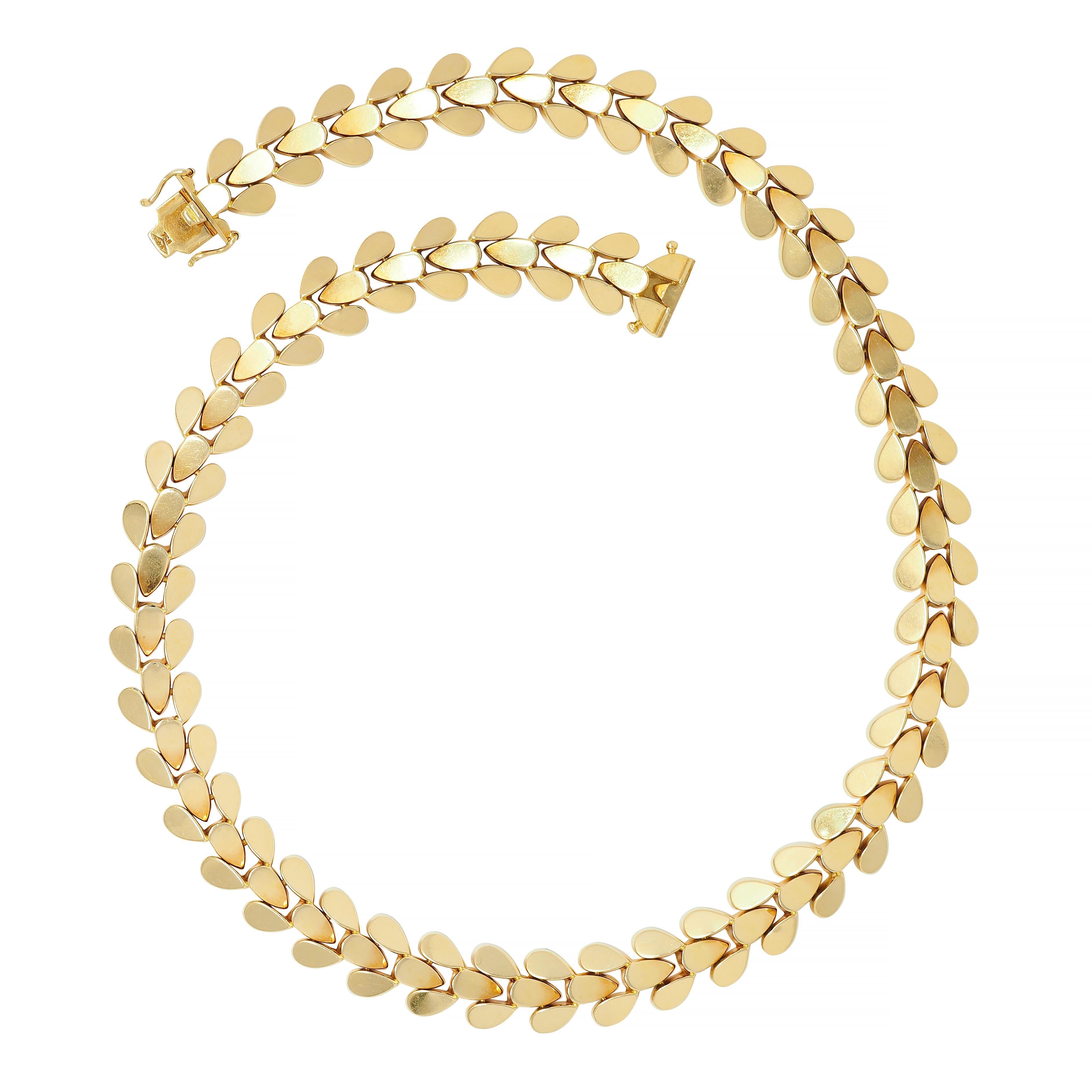 Comprised of tiered minimalist foliate motif links 
Hinged with considerable flex 
Completed by concealed clasp closure
With hinged double figure eight safety
Stamped for 18 karat gold 
Numbered and fully signed for Cartier, CA. 
Circa: 1970s
Width