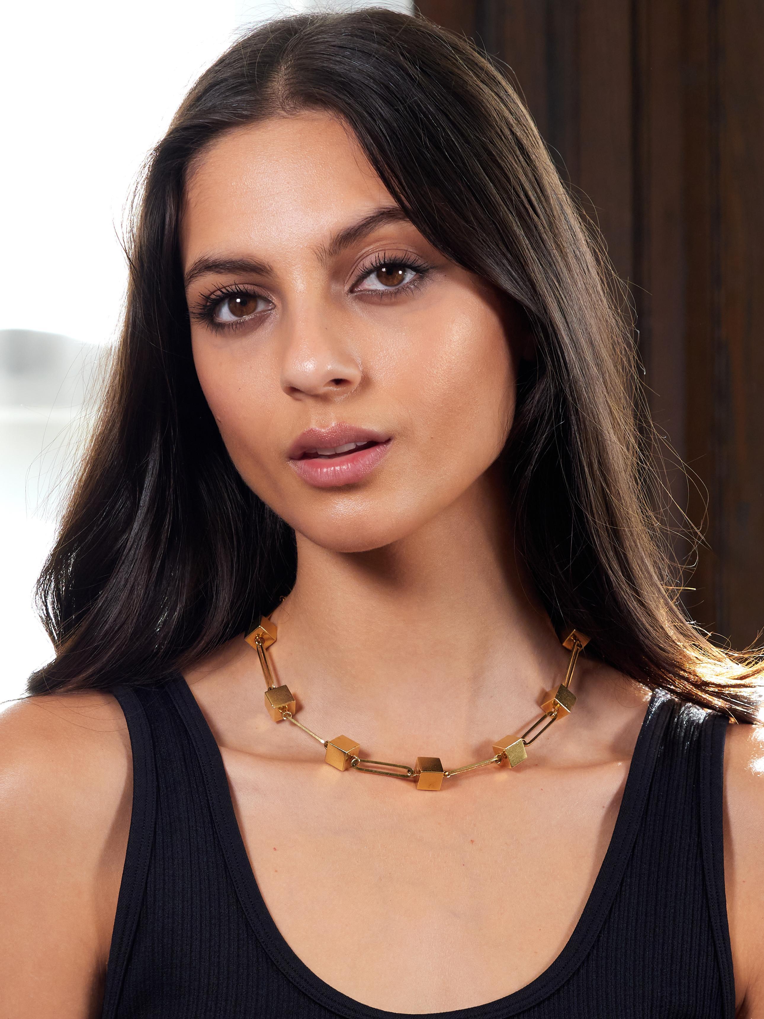 Designed as an elongated paperclip link chain
Accented by eleven cube shaped stations
With a high polish finish
Stamped for 18 karat gold
Numbered and fully signed for Cartier
Circa: 1970s
Width at Widest: 3/8 inch
Length: 16 1/2 inches
Total